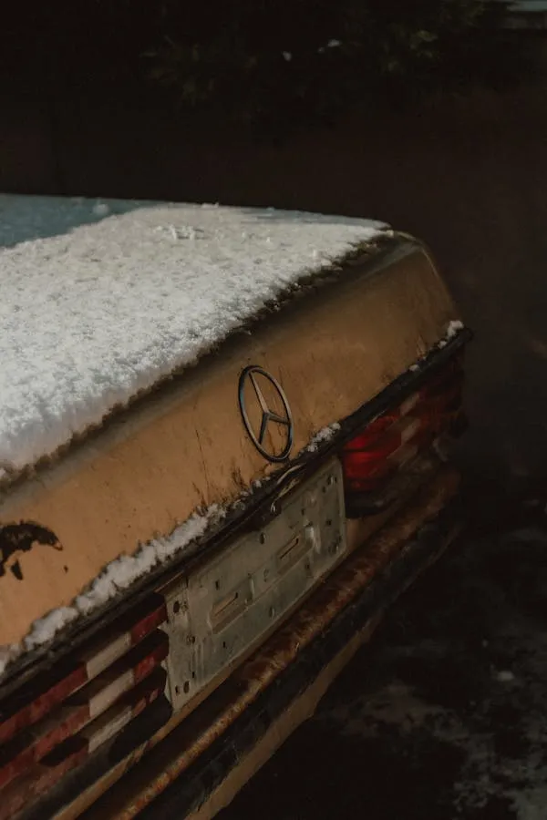 Rear Trunk View of Old Mercedes Benz with Snow Cover