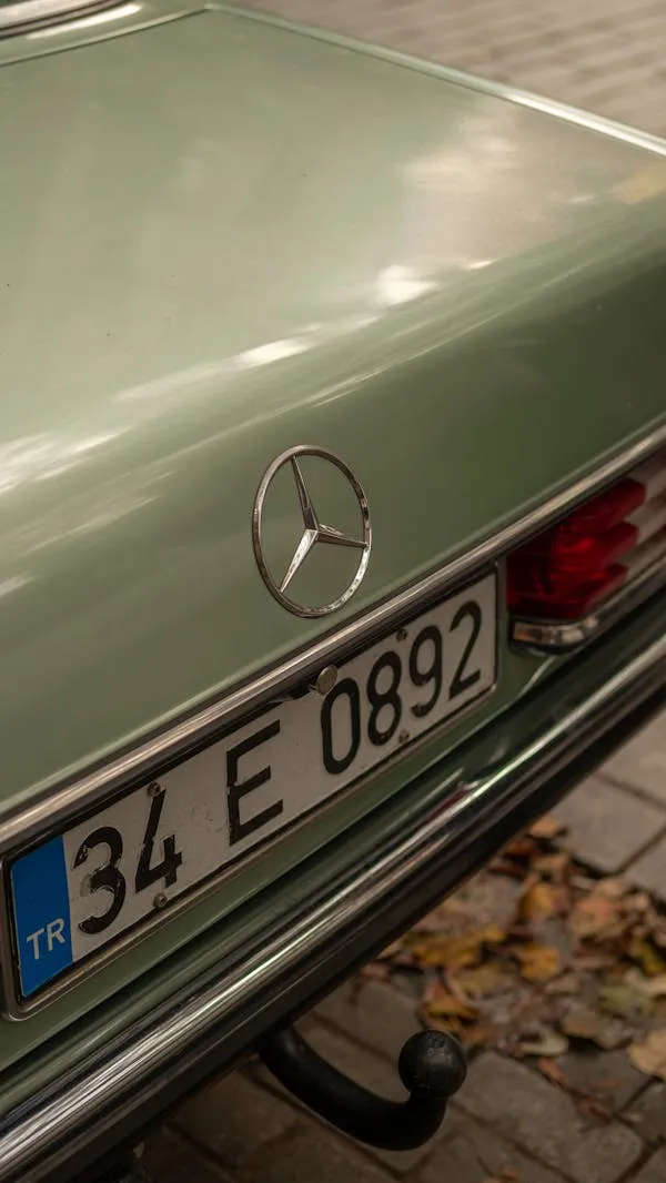 Rear view of a mint green Mercedes with license plate