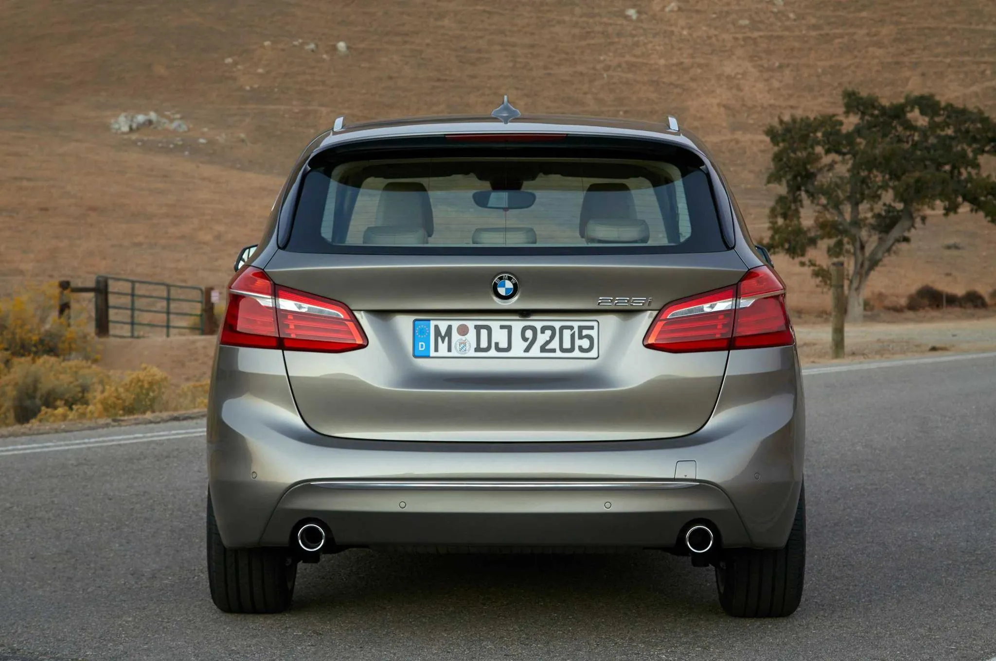 Rear View of a Silver Bmw Suv on a Country Road Wallpaper