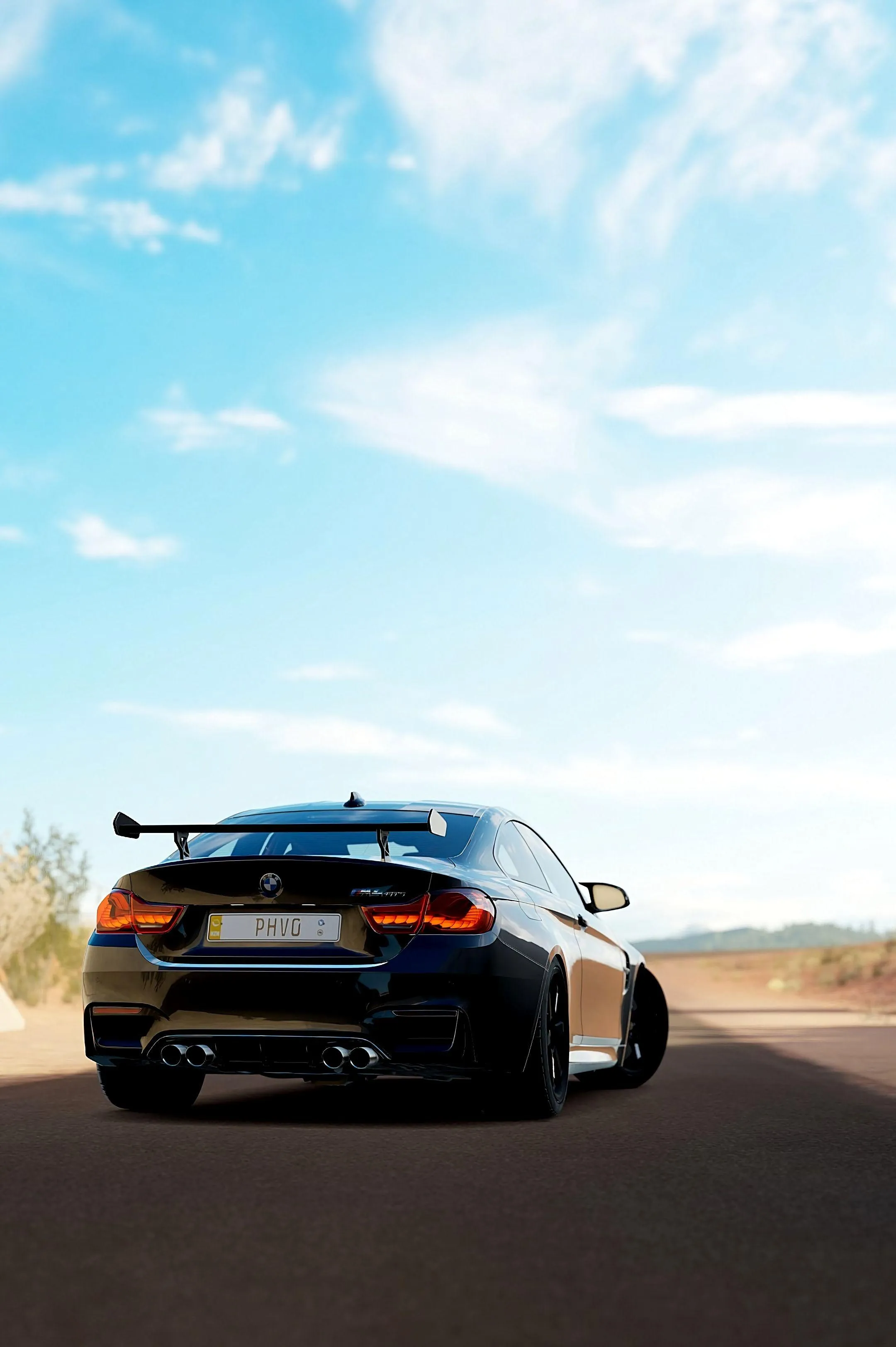 Rear View of Black Bmw Car Driving Toward Clear Sky