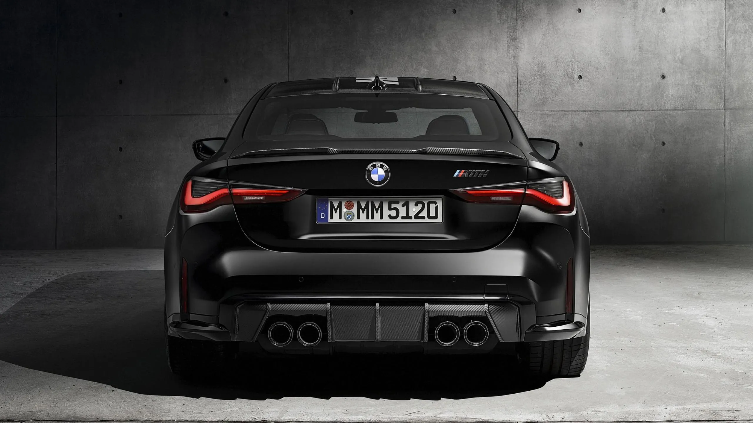Rear View of Black Bmw Parked Indoors with Dark Backdrop