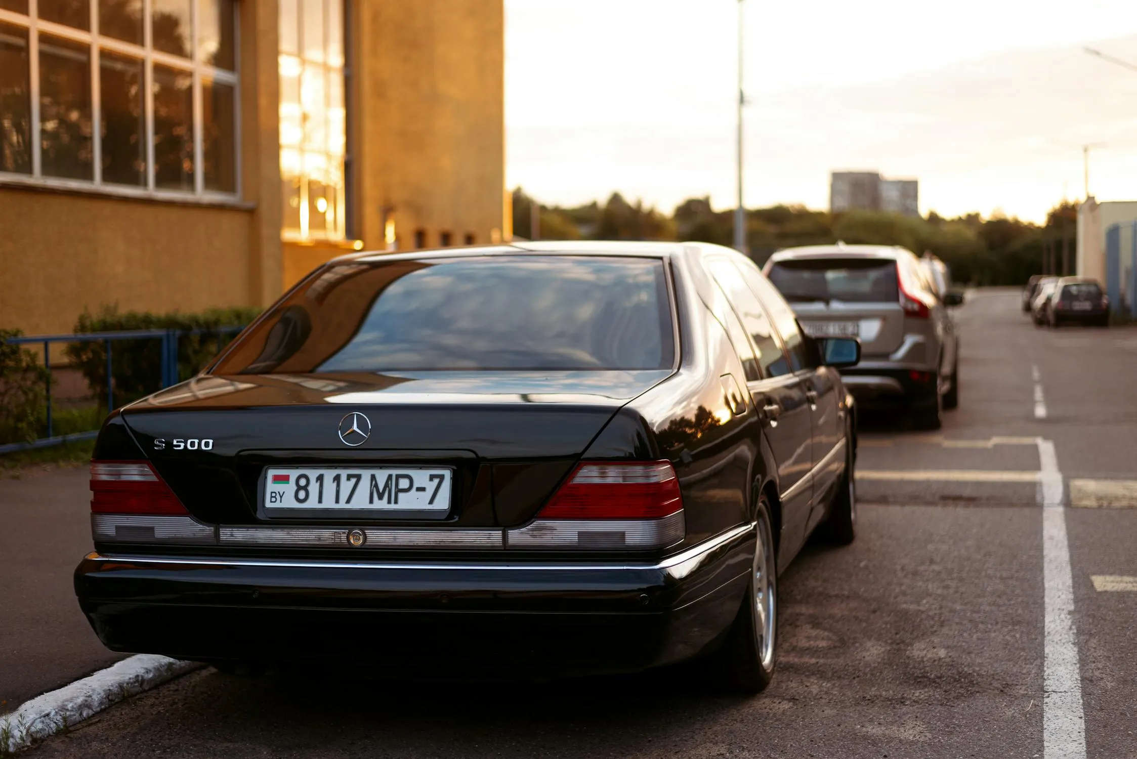 Rear View of Black Mercedes Benz Sedan Parked on City Street