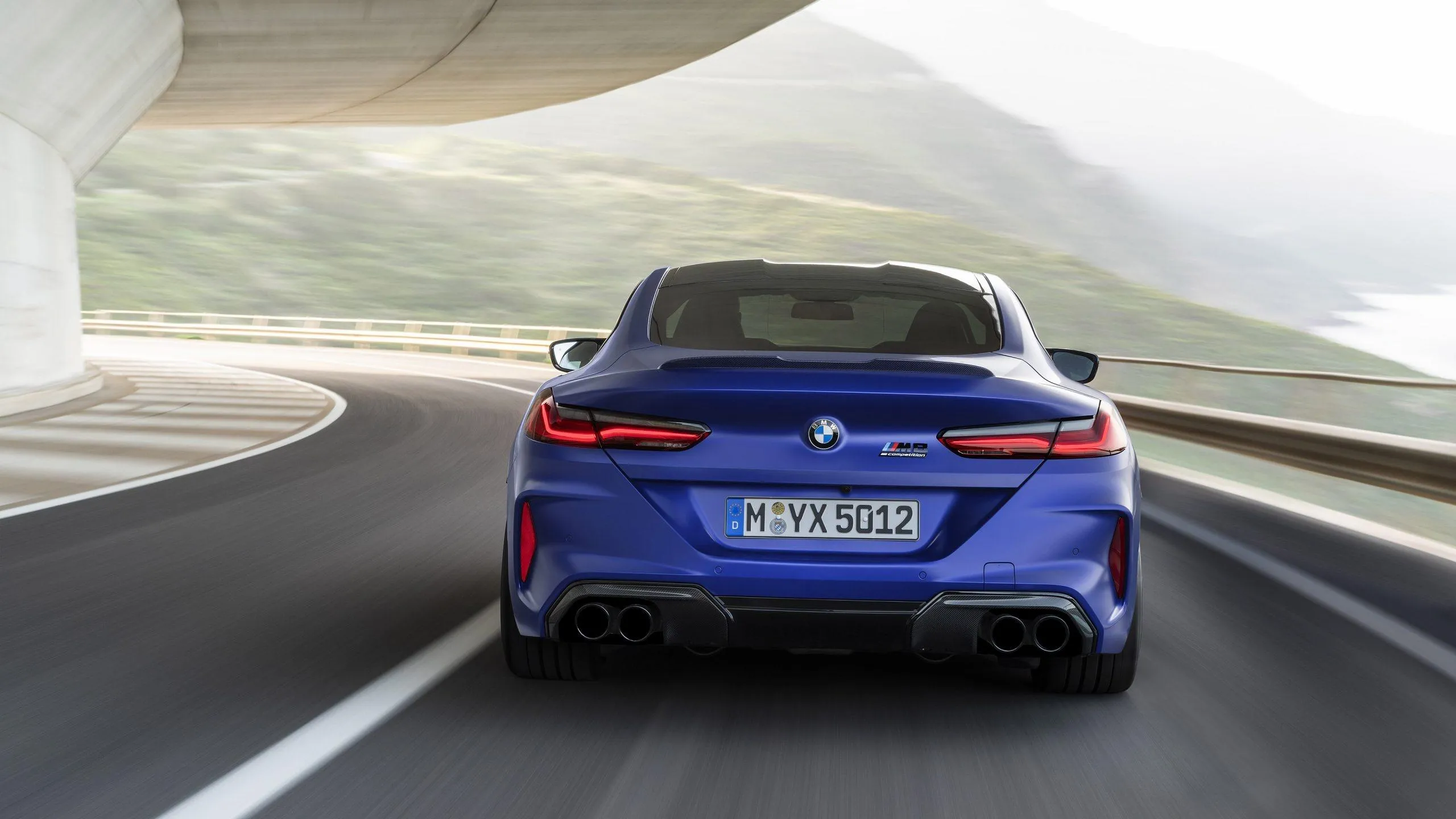 Rear View of Blue Bmw Driving Fast on a Curved Freeway