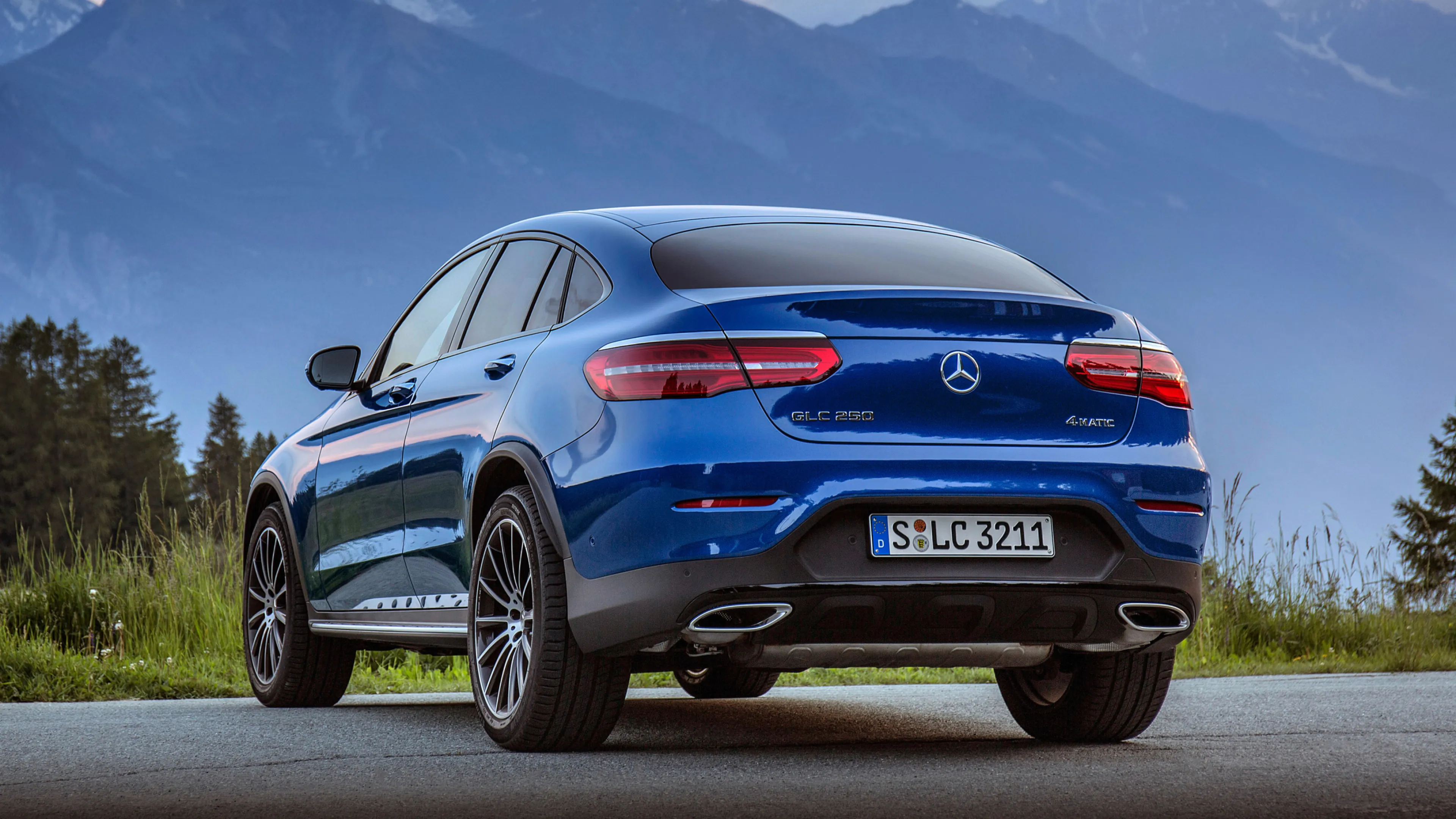 Rear View of Blue Mercedes Benz SUV on Open Road Wallpaper