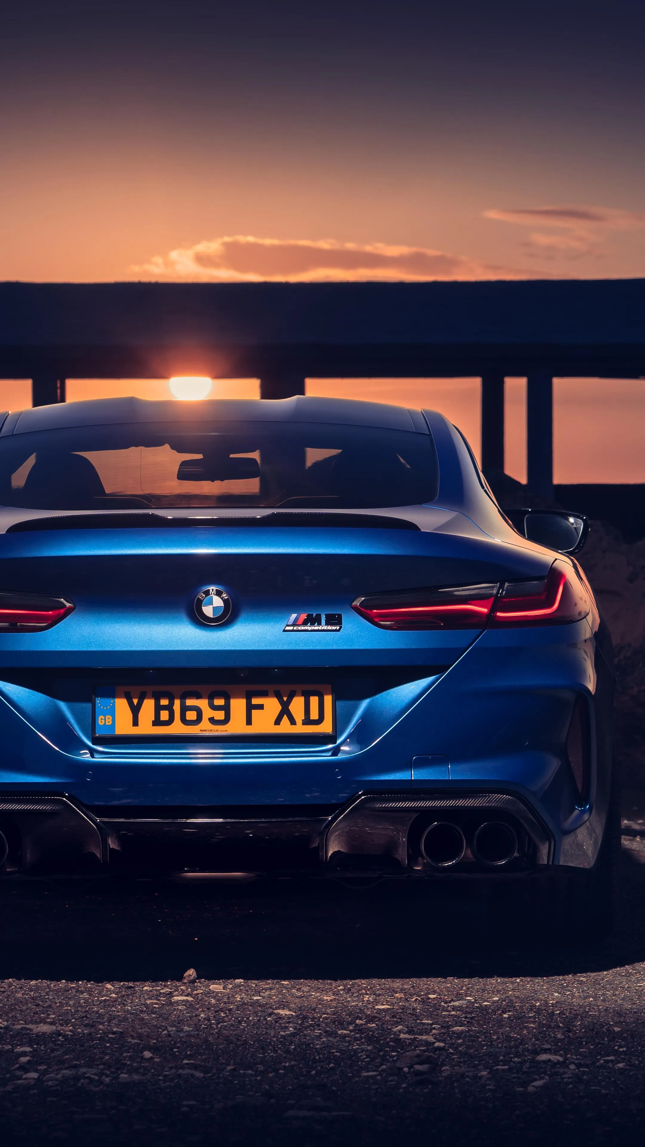 Rear View of Bmw at Sunset with Exhaust Pipes Glowing