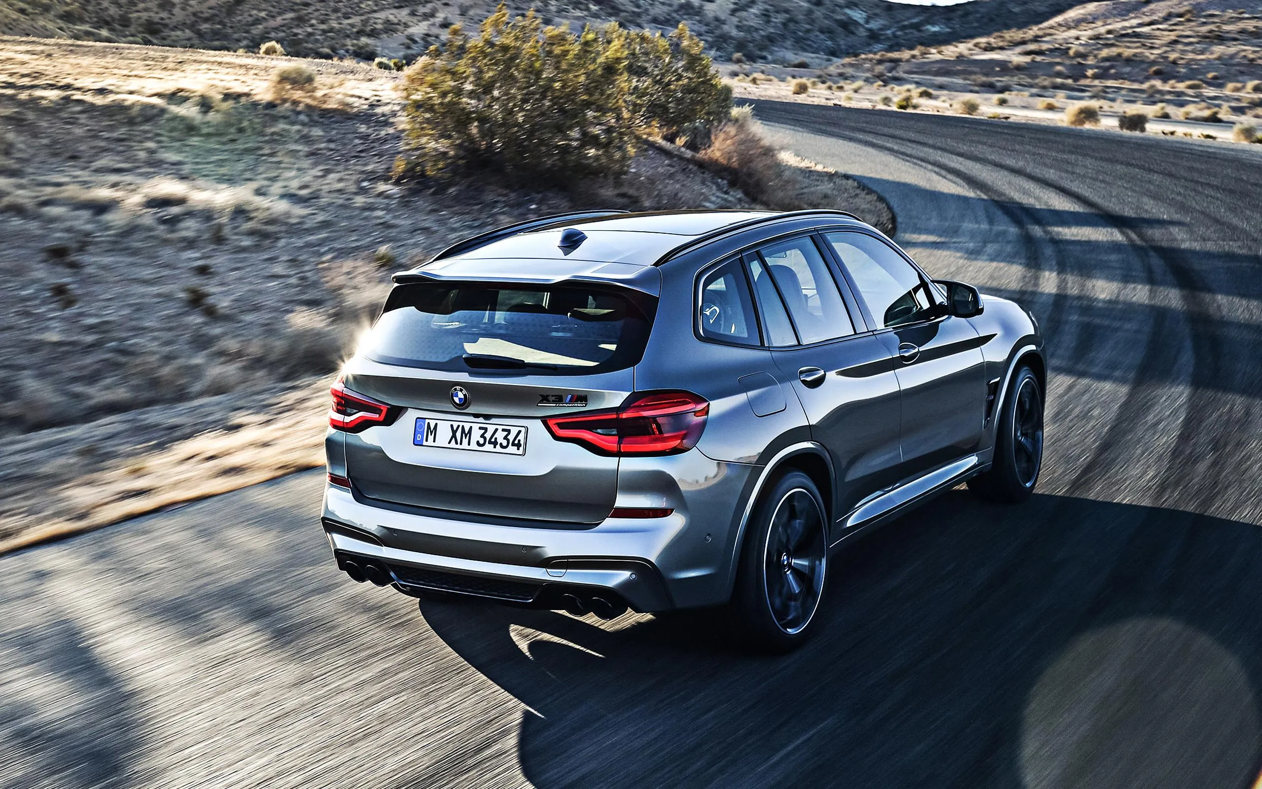 Rear View of Bmw Suv Driving on Curvy Mountain Road