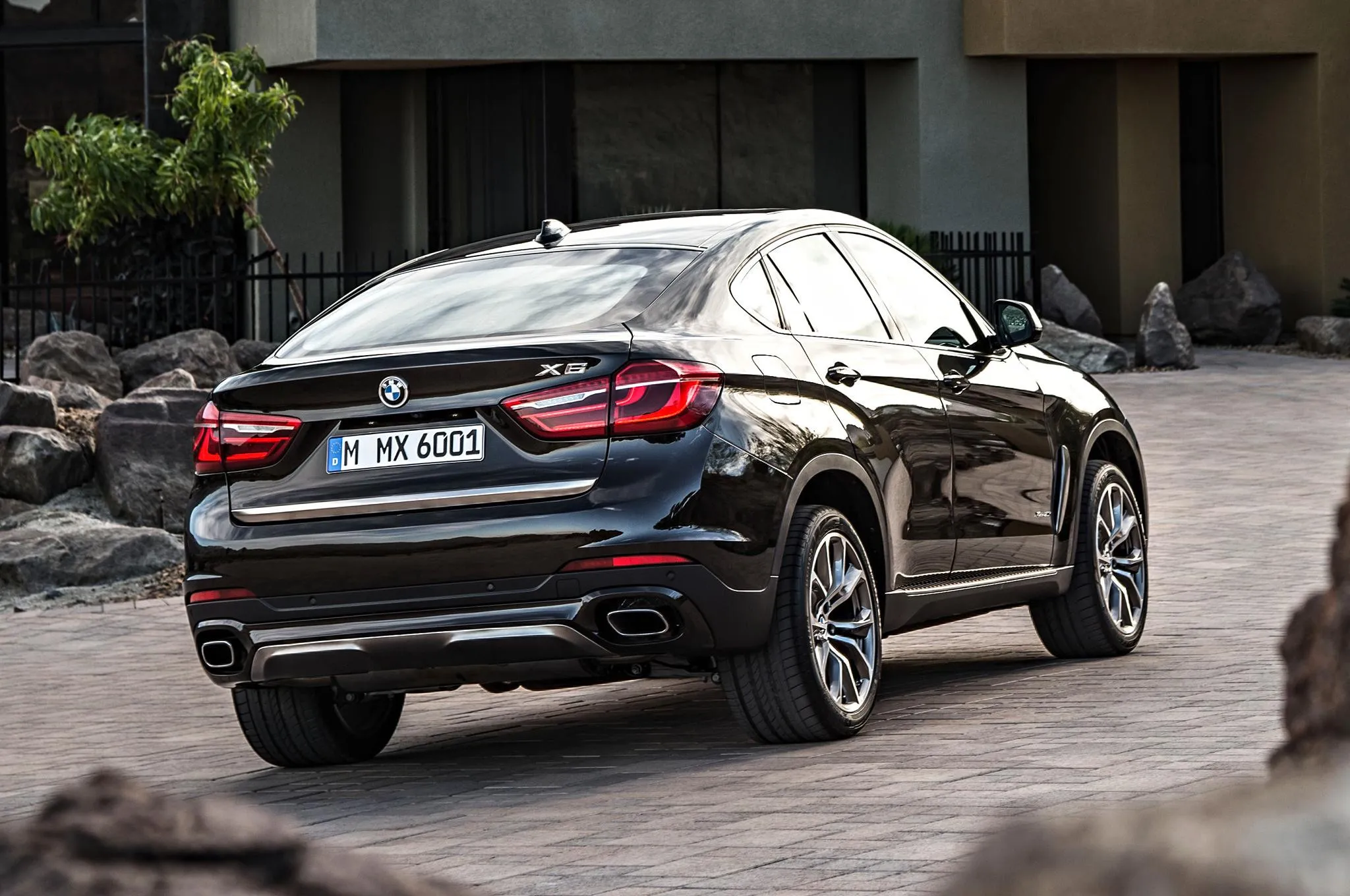 Rear View of Bmw Suv Parked Near Modern Building Wallpaper