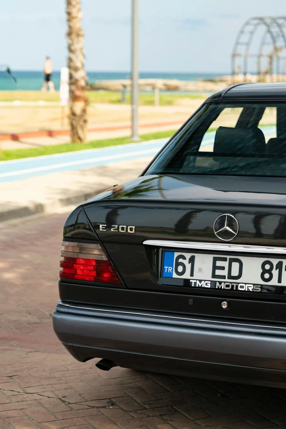 Rear View of Classic Black Mercedes Benz with License