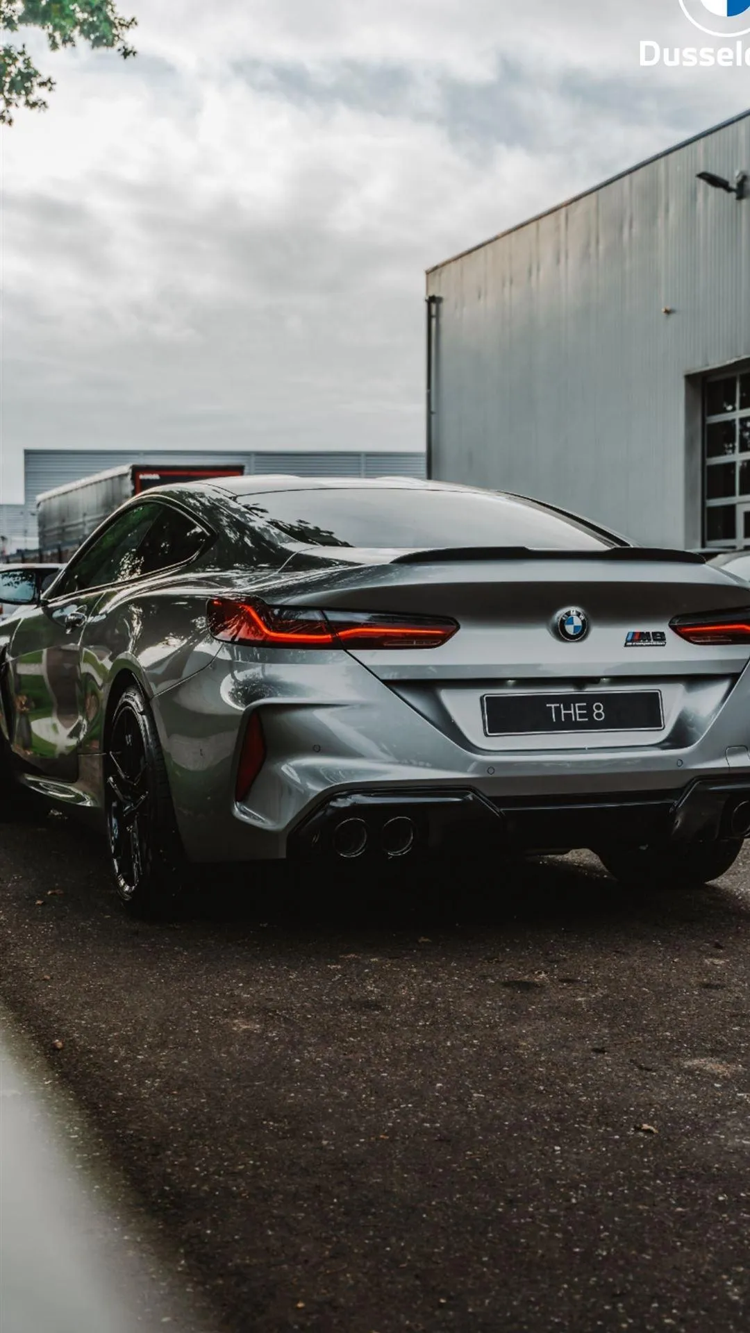 Rear View of Silver Bmw Car Parked Beside Warehouse