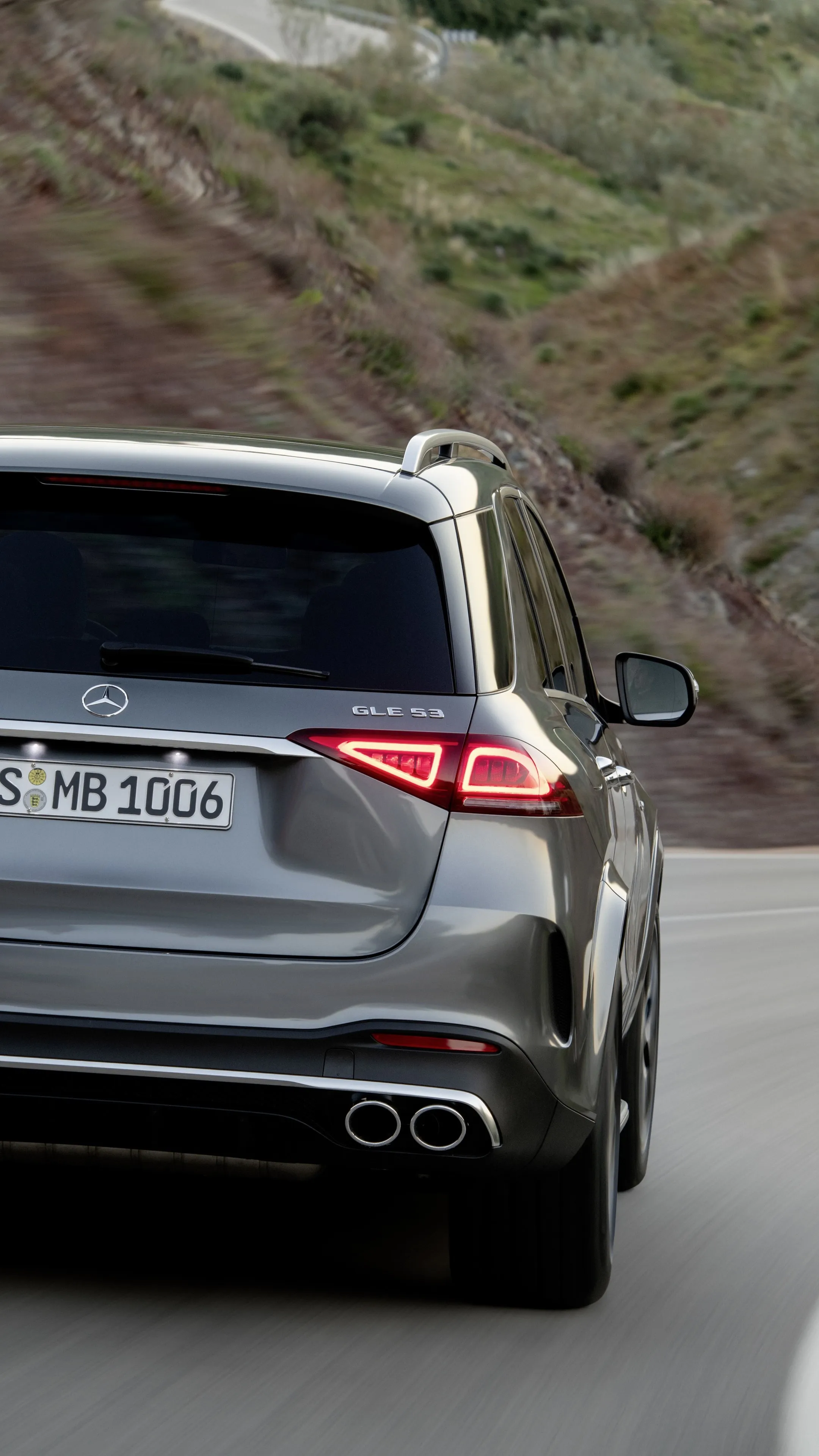 Rear View of Silver Mercedes Benz SUV Driving on Road