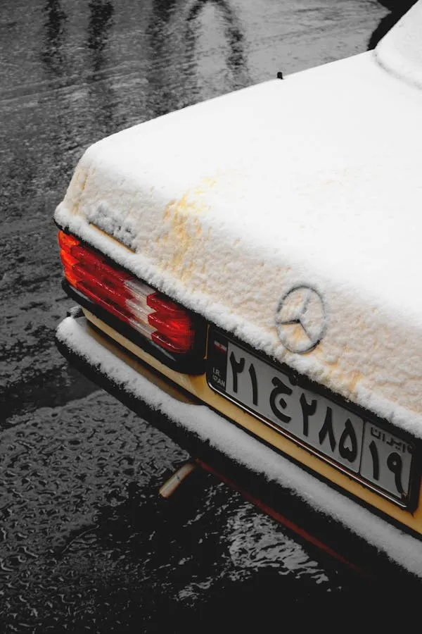 Rear View of Snow Covered Classic Mercedes Benz Car