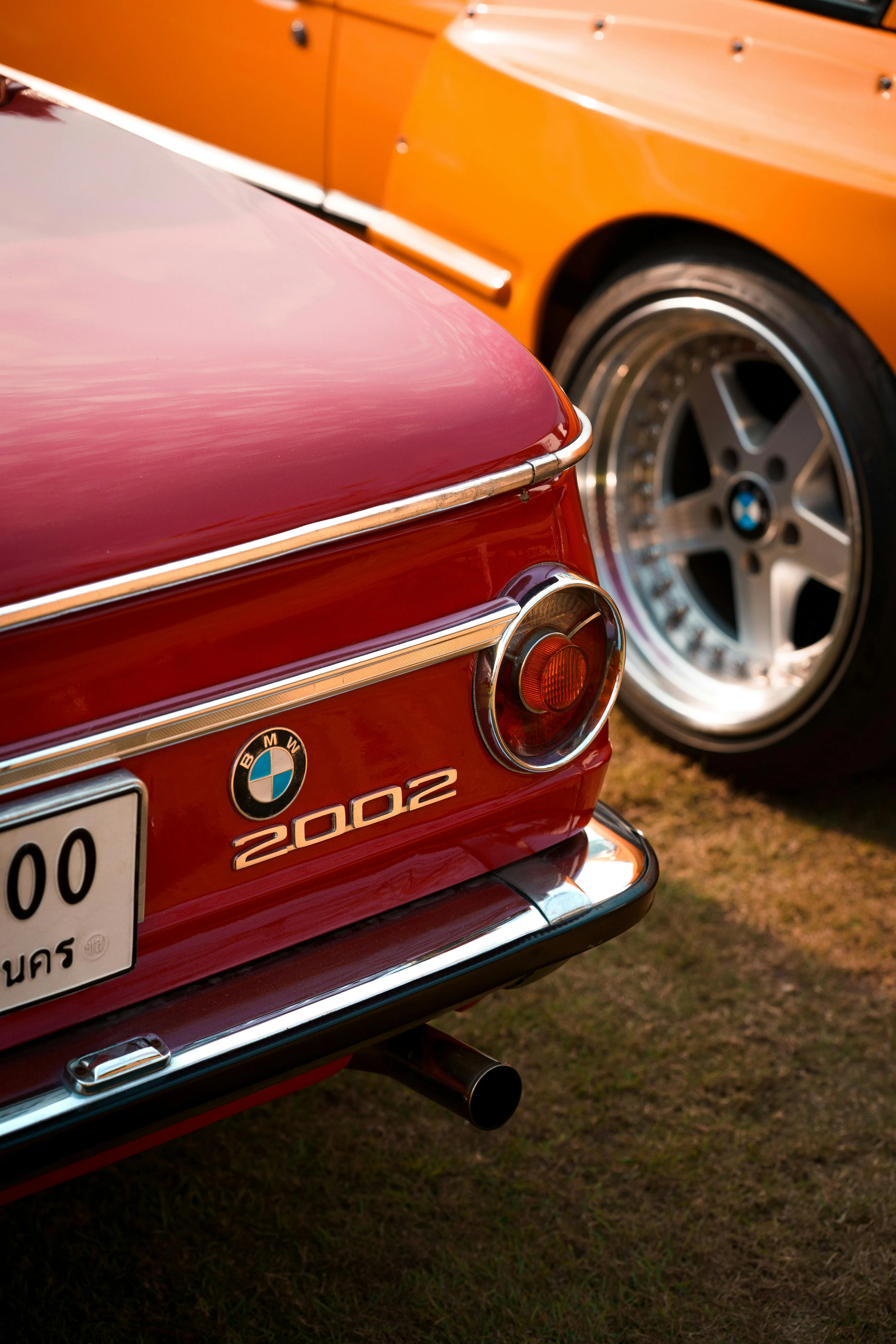 Rear View of Vintage Red Bmw 2002 with Chrome Details