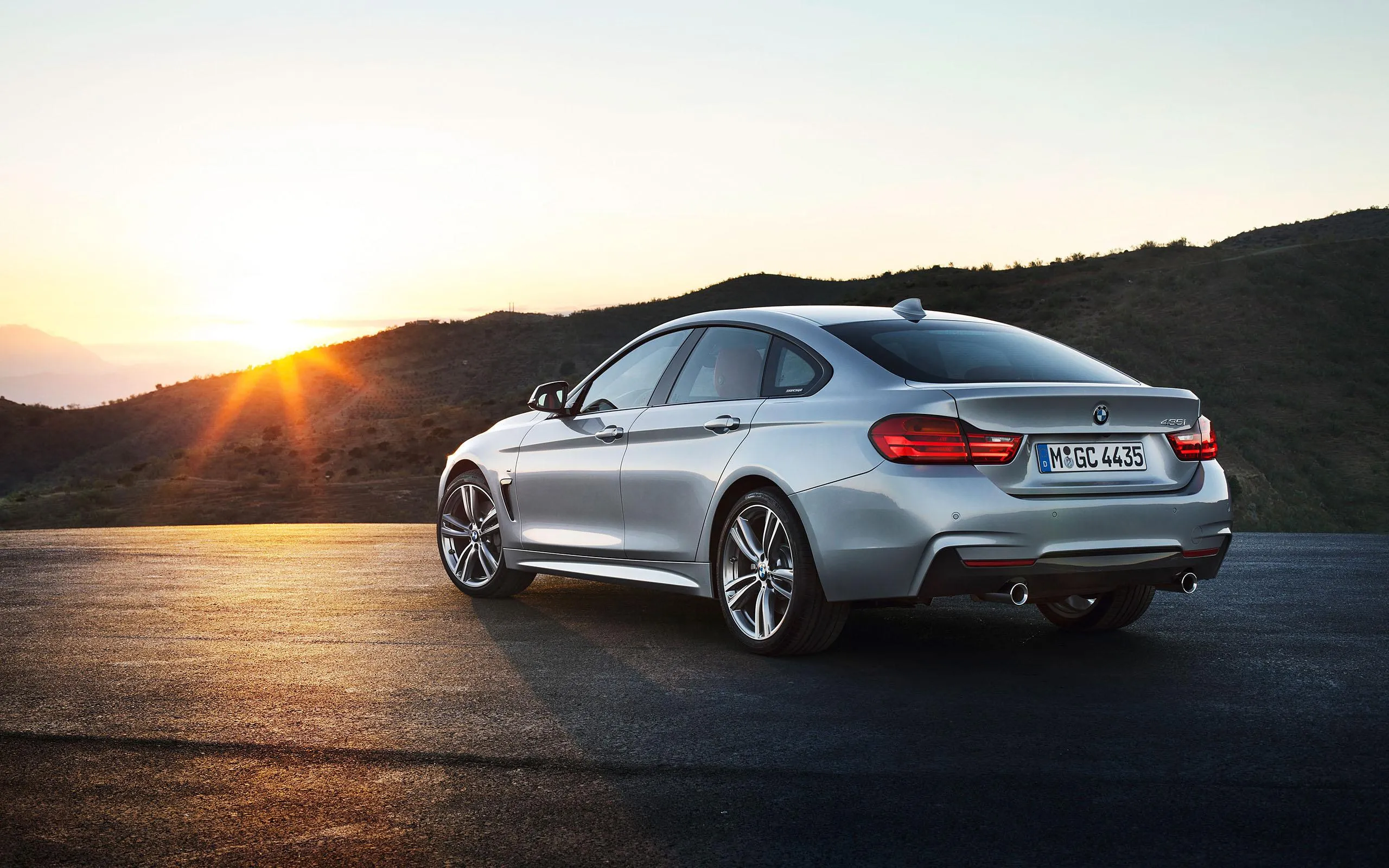 Rear View of White Bmw Sedan at Sunrise on Open Road