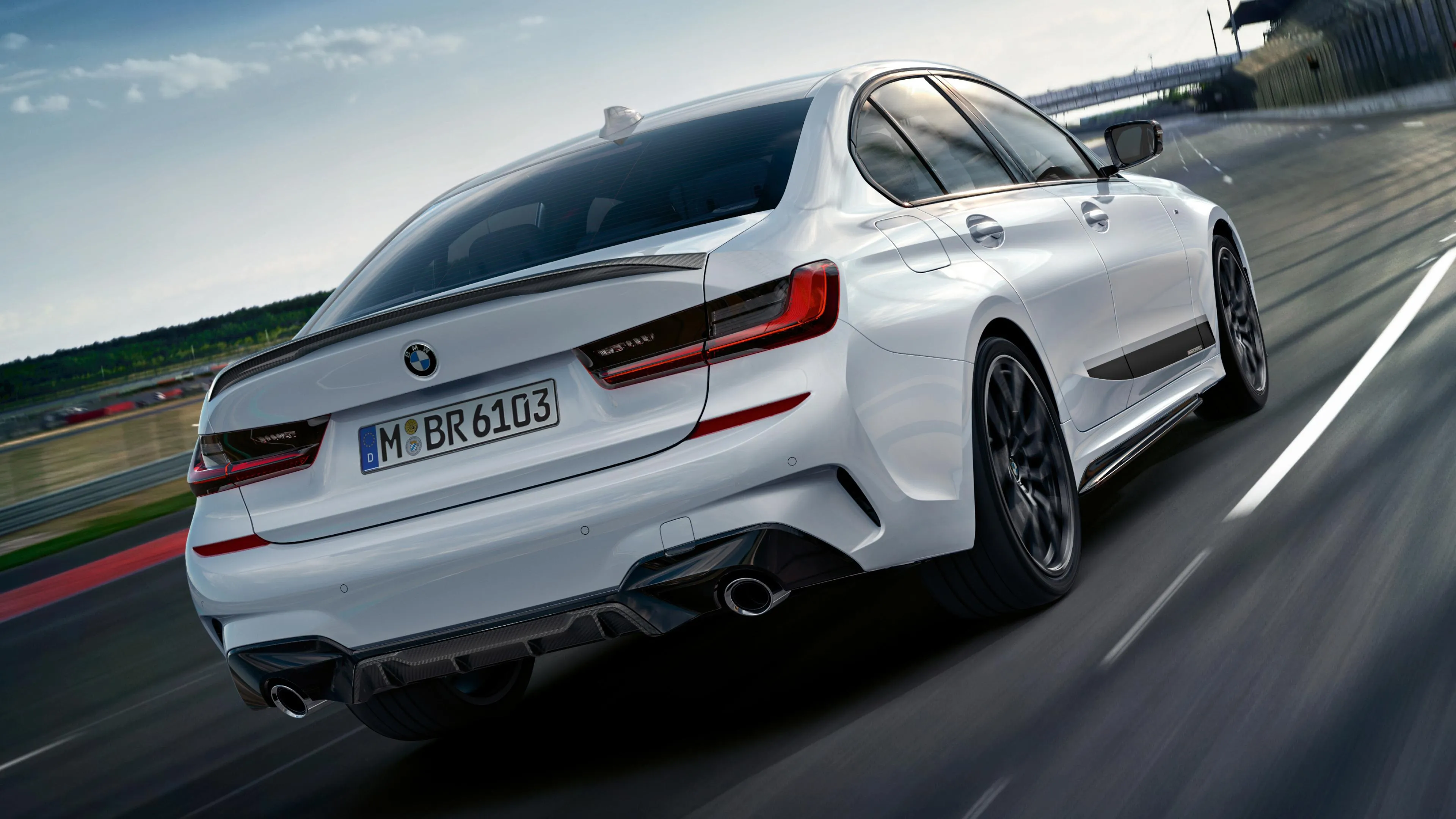 Rear View of White Bmw Speeding Along Coastal Highway