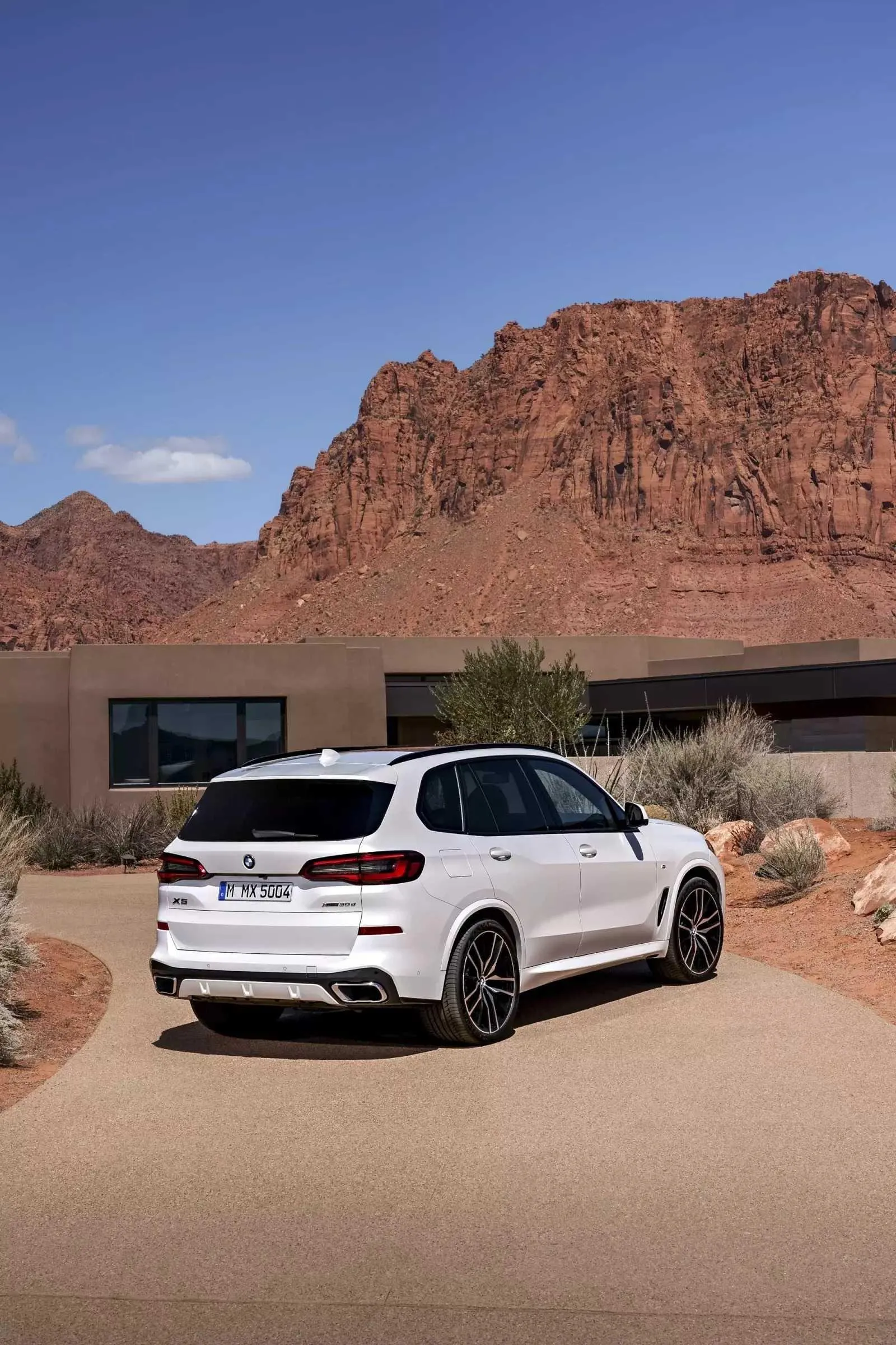Rear View of White Bmw Suv Near Desert Landscape Wallpaper