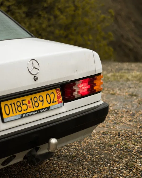 Rear View of White Classic Mercedes Benz with License