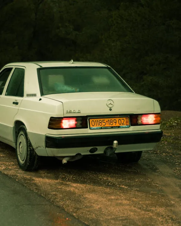 Rear View of White Vintage Mercedes Benz on Dirt Road