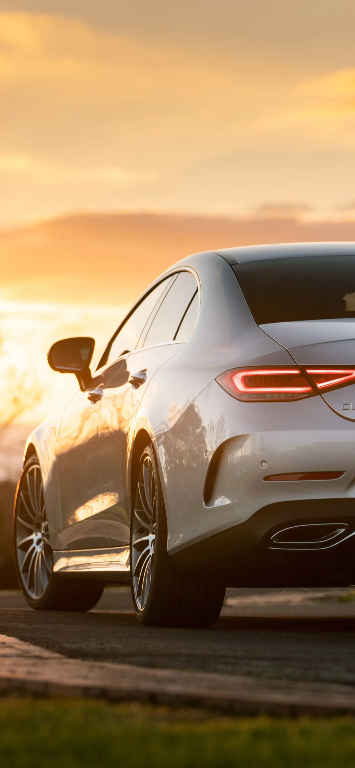 Rear View White Mercedes Benz Car on Road at Sunset