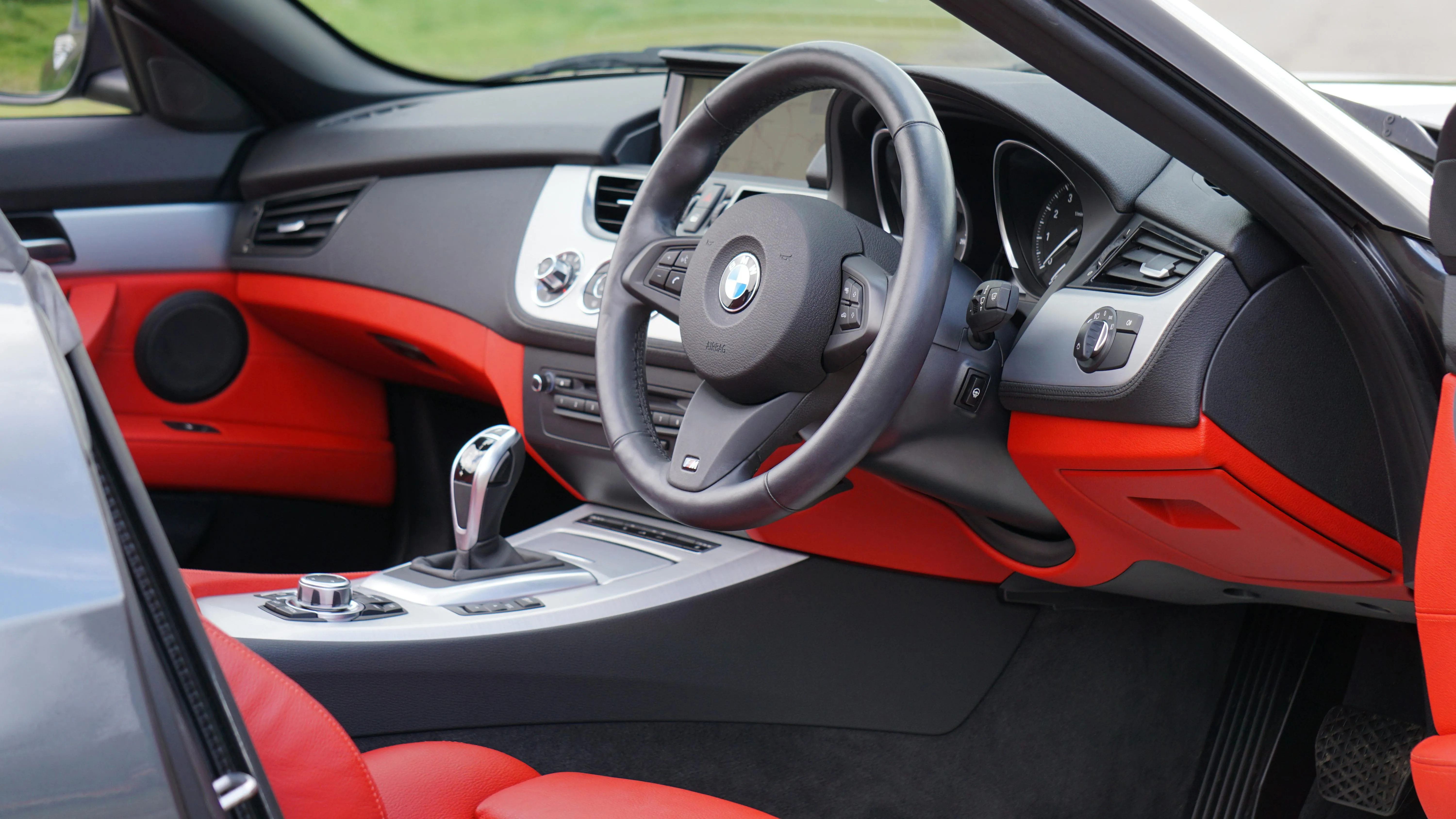 Red and Black Bmw Interior Showing Wheel and Gear Shift Area