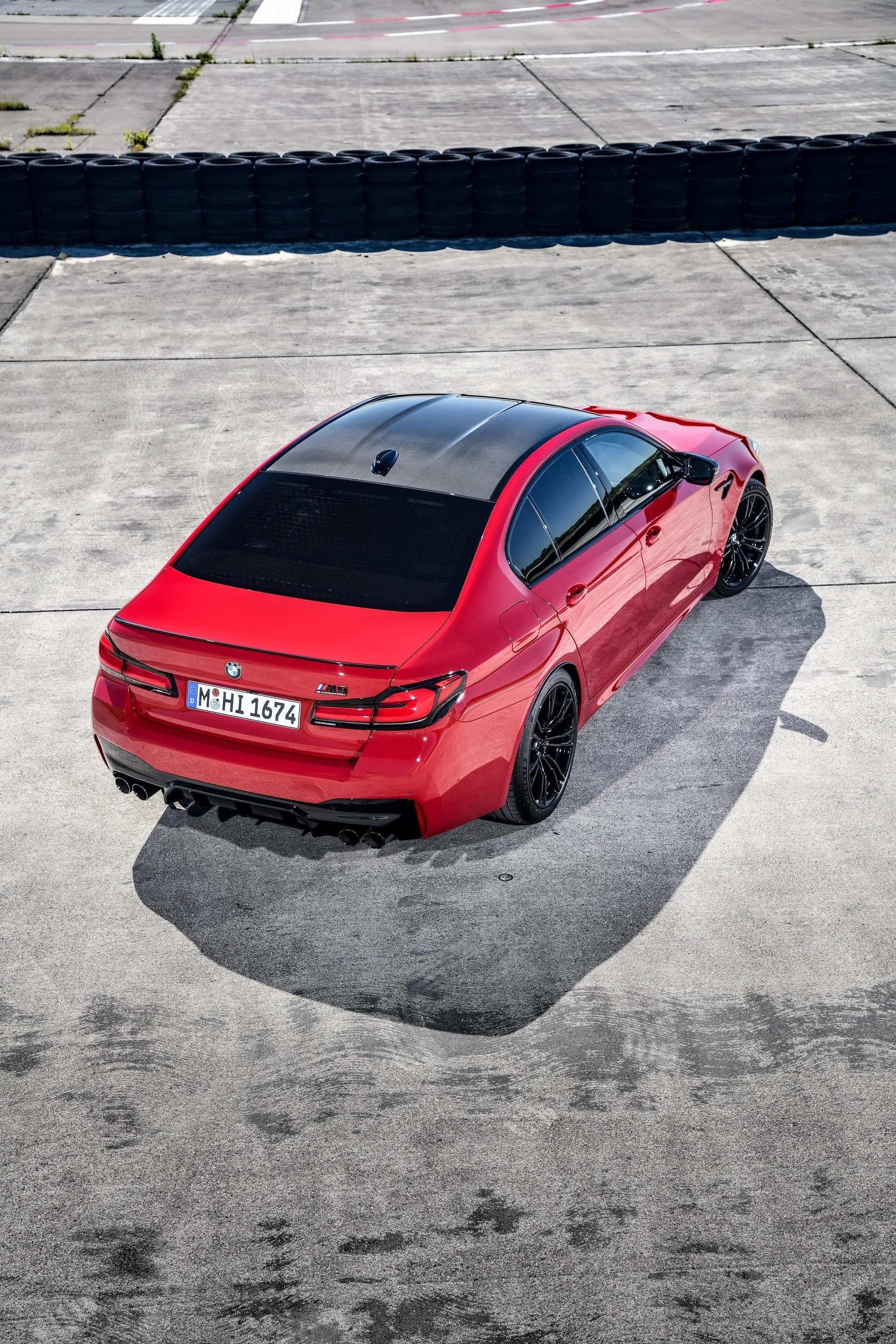 Red Bmw Captured From Above While Parked on Grey Concrete