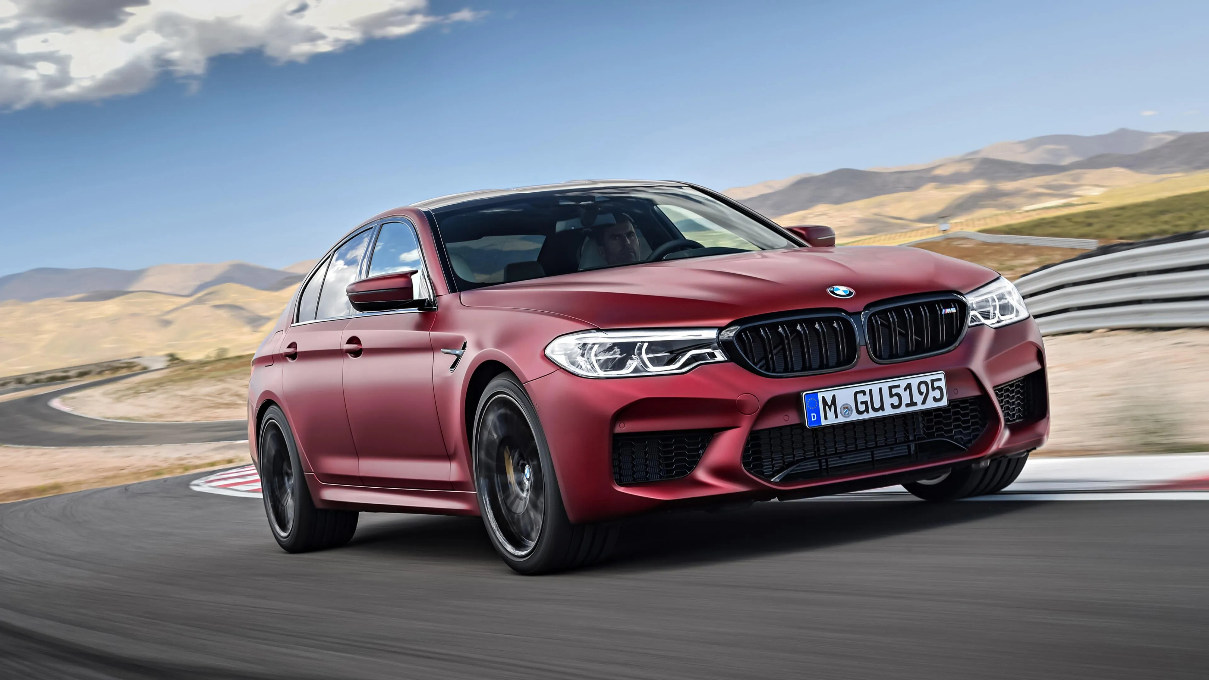 Red Bmw Car Driving Fast on an Open Road Wallpaper Download
