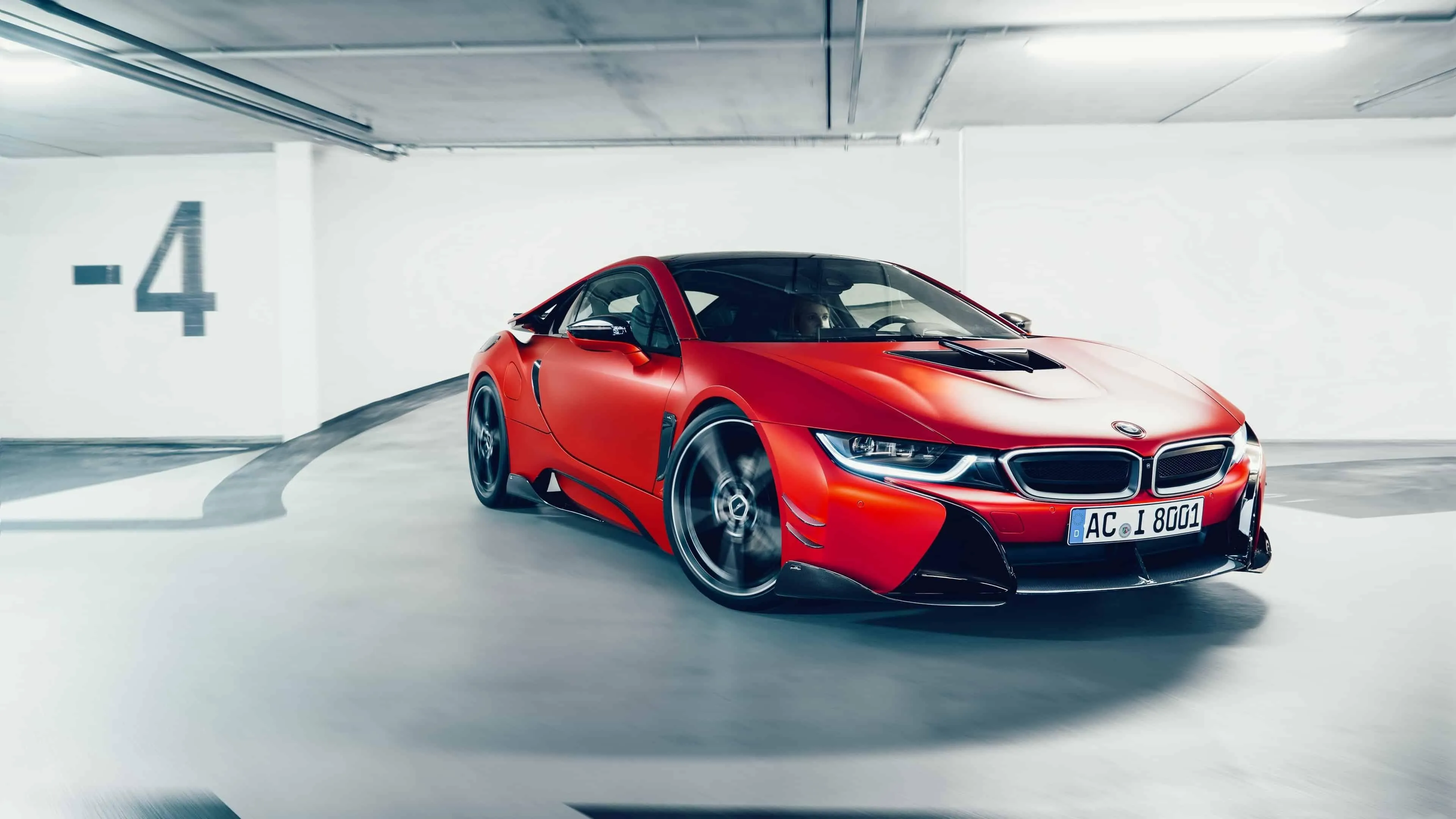 Red Bmw Car Parked Indoors in Underground Garage Level Four
