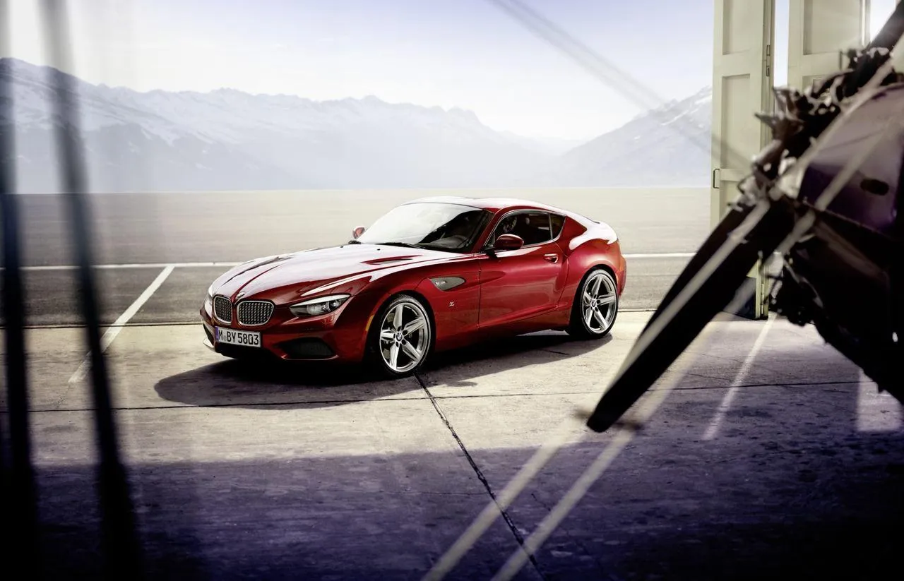 Red Bmw Car Parked Near a Helicopter on Tarmac Wallpaper