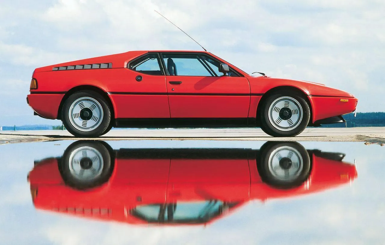 Red Bmw Classic Sports Car Reflected on Glass Surface