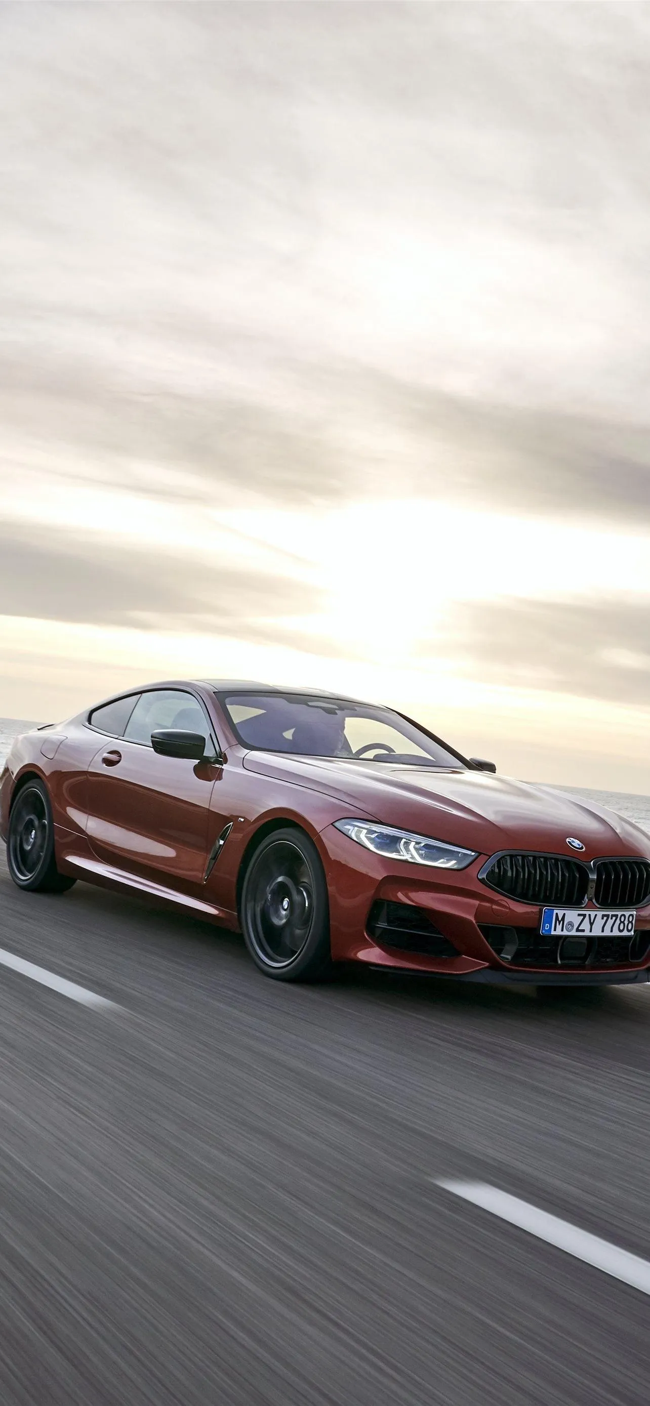 Red Bmw Coupe Driving on Open Road at Golden Sunset