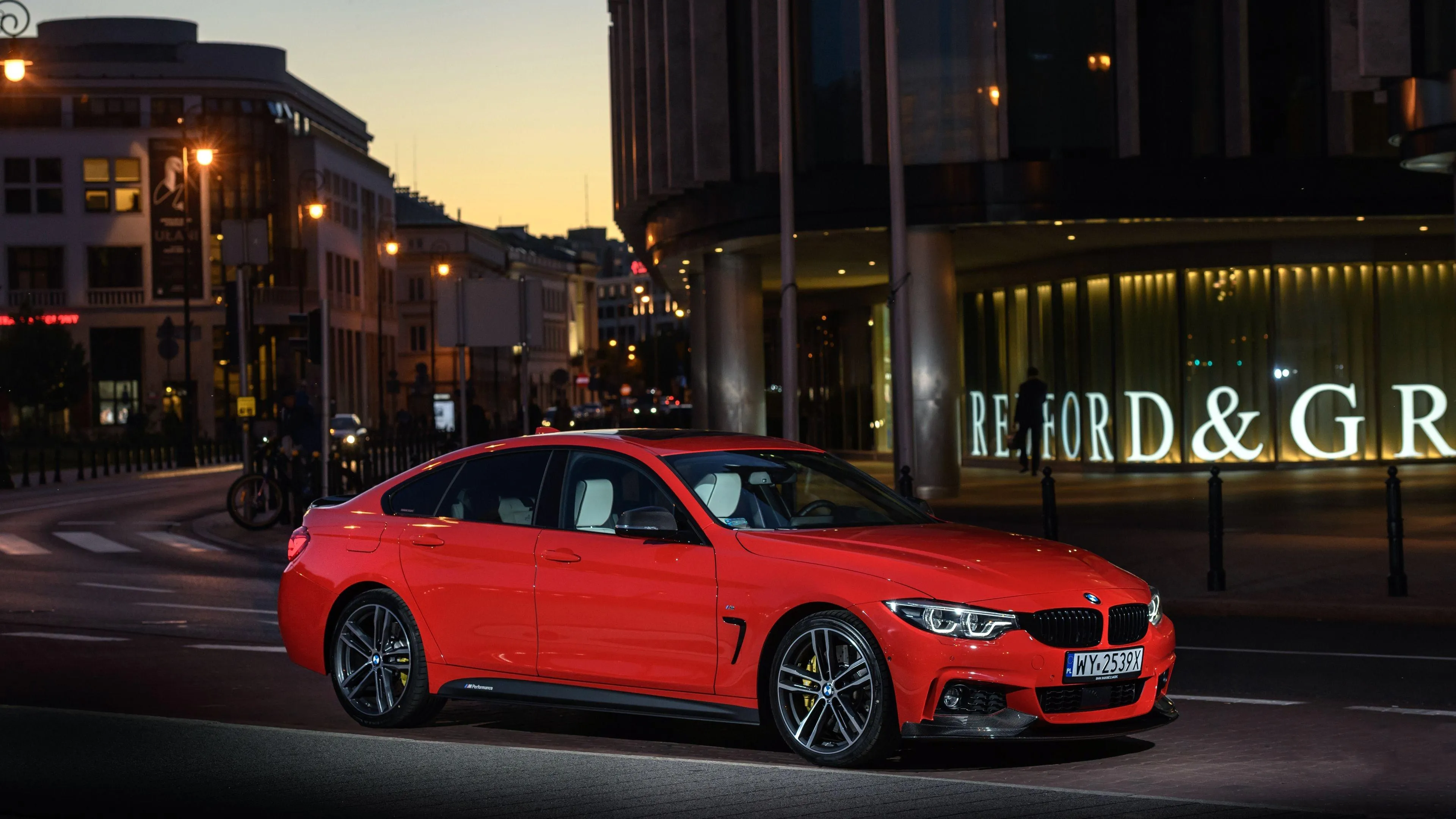 Red Bmw Coupe Parked Near City Street at Night Wallpaper