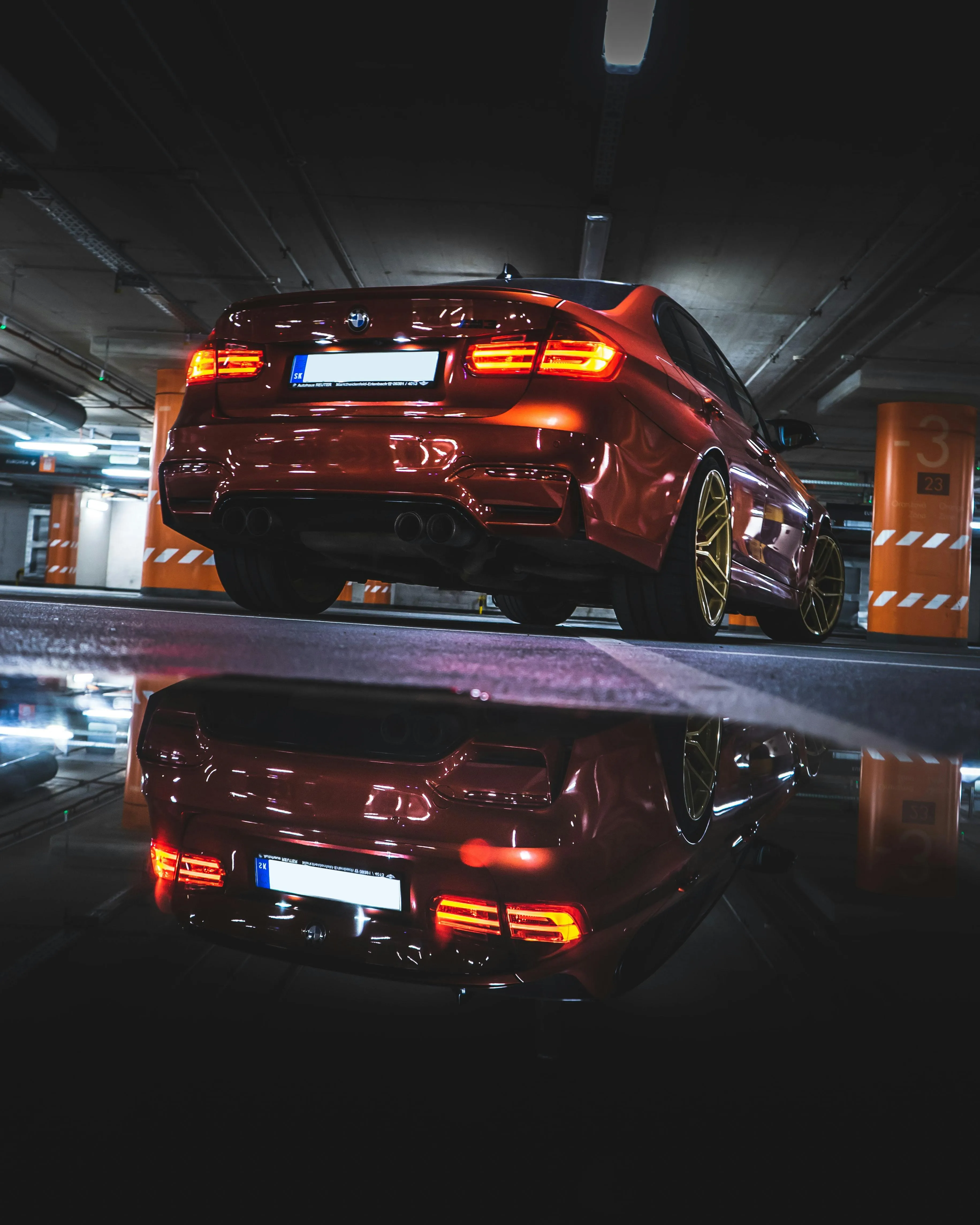 Red Bmw in Parking Garage with Neon Reflections on Floor