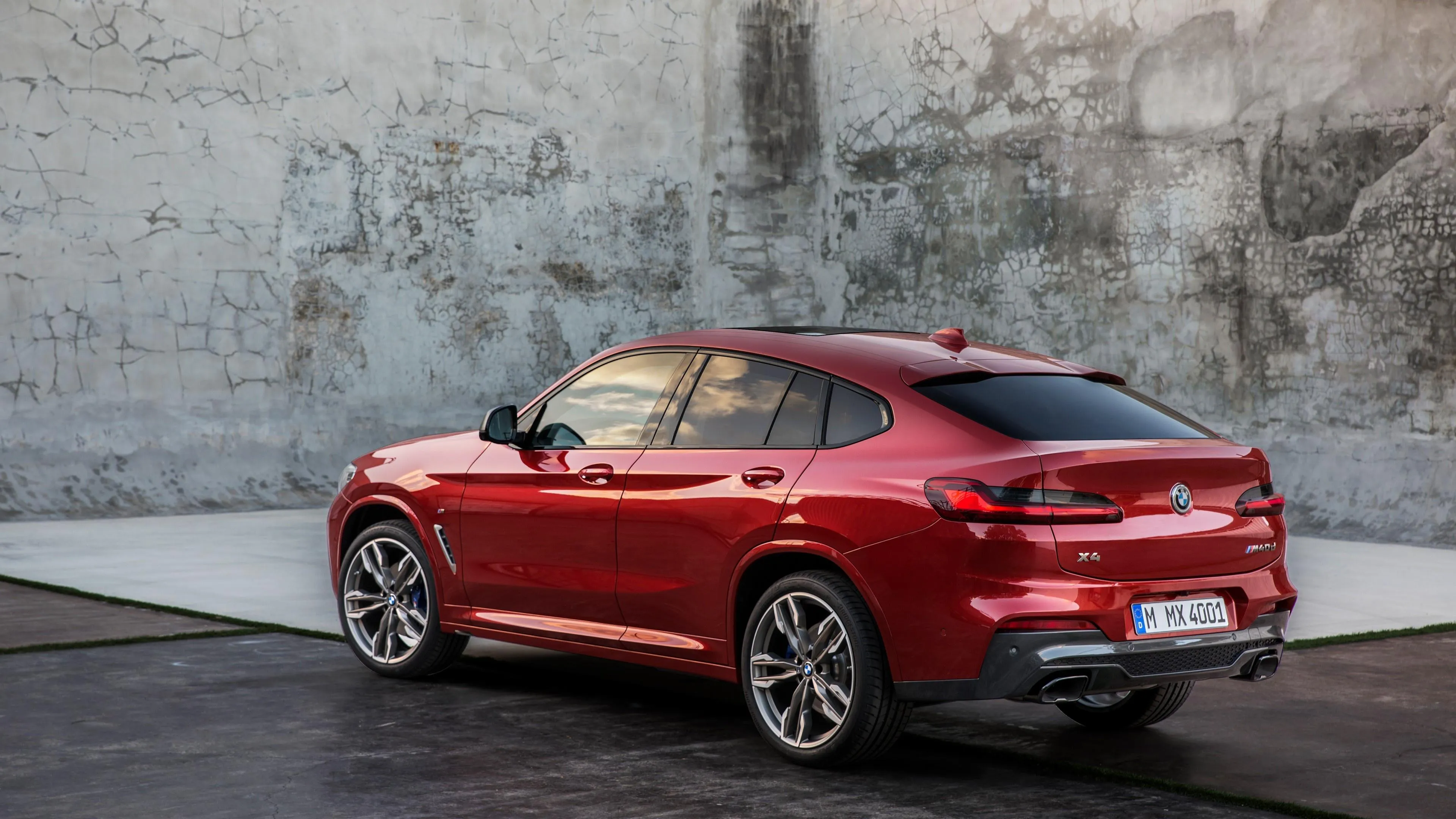 Red Bmw Parked Against Concrete Wall Under Soft Daylight