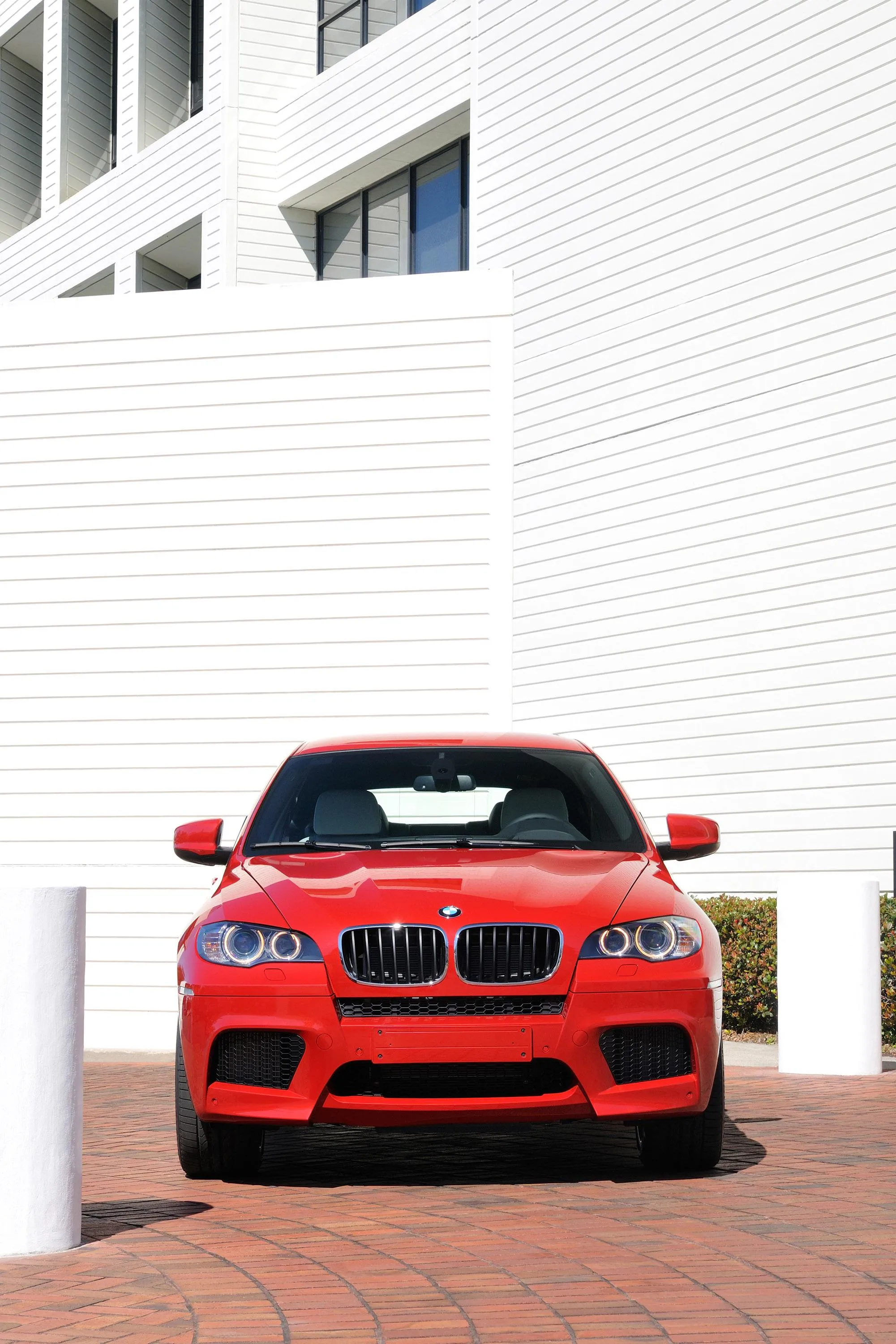 Red Bmw Parked in Front of White Modern Building Wallpaper