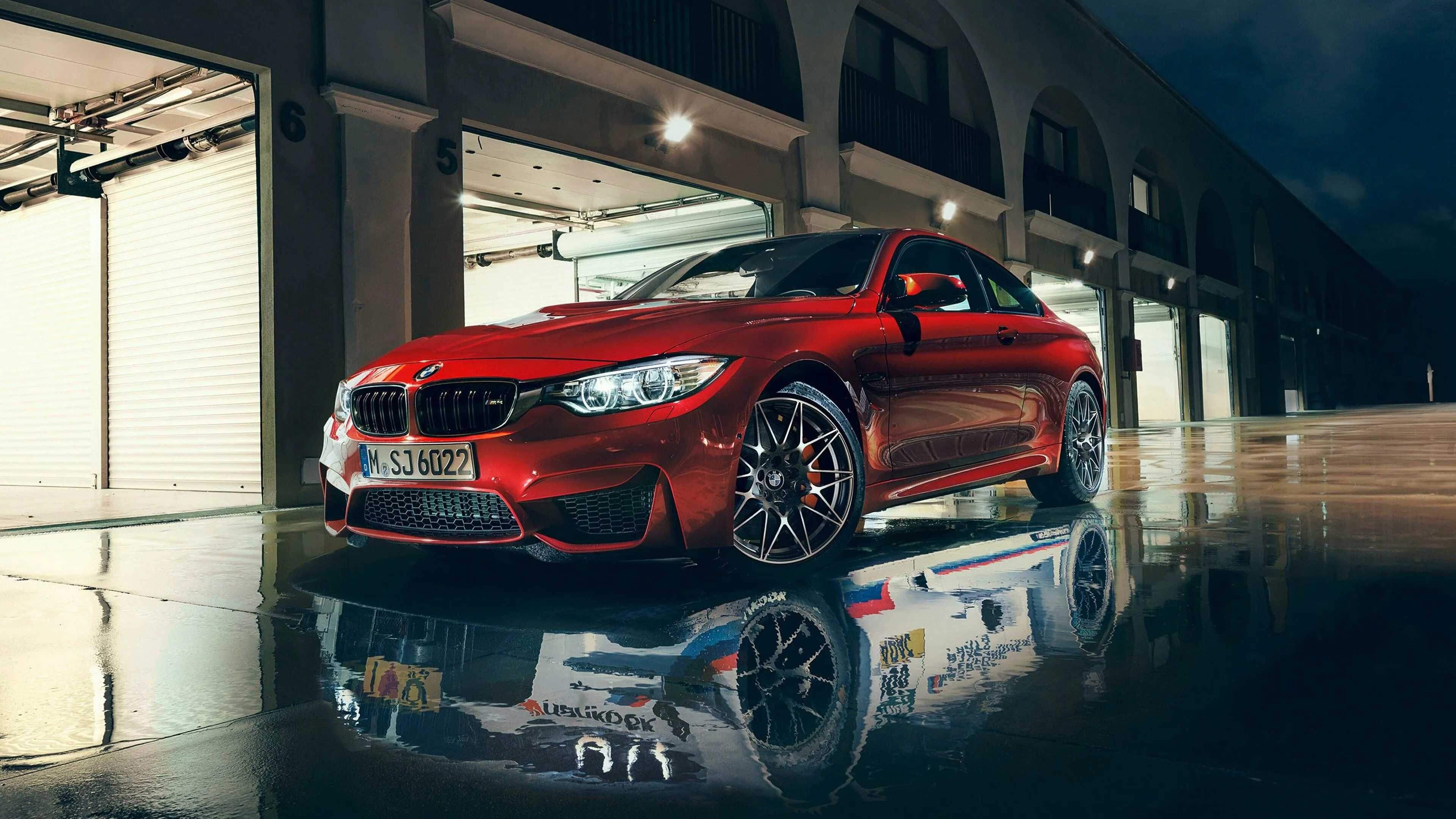 Red Bmw Parked Inside Modern Garage with Reflections