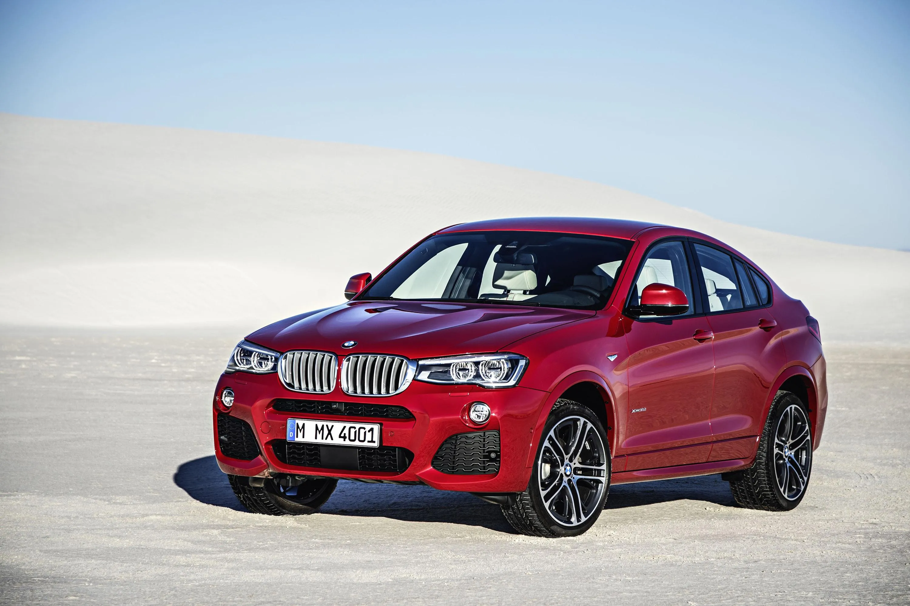 Red Bmw Parked on White Ground in a Sunny Open Space