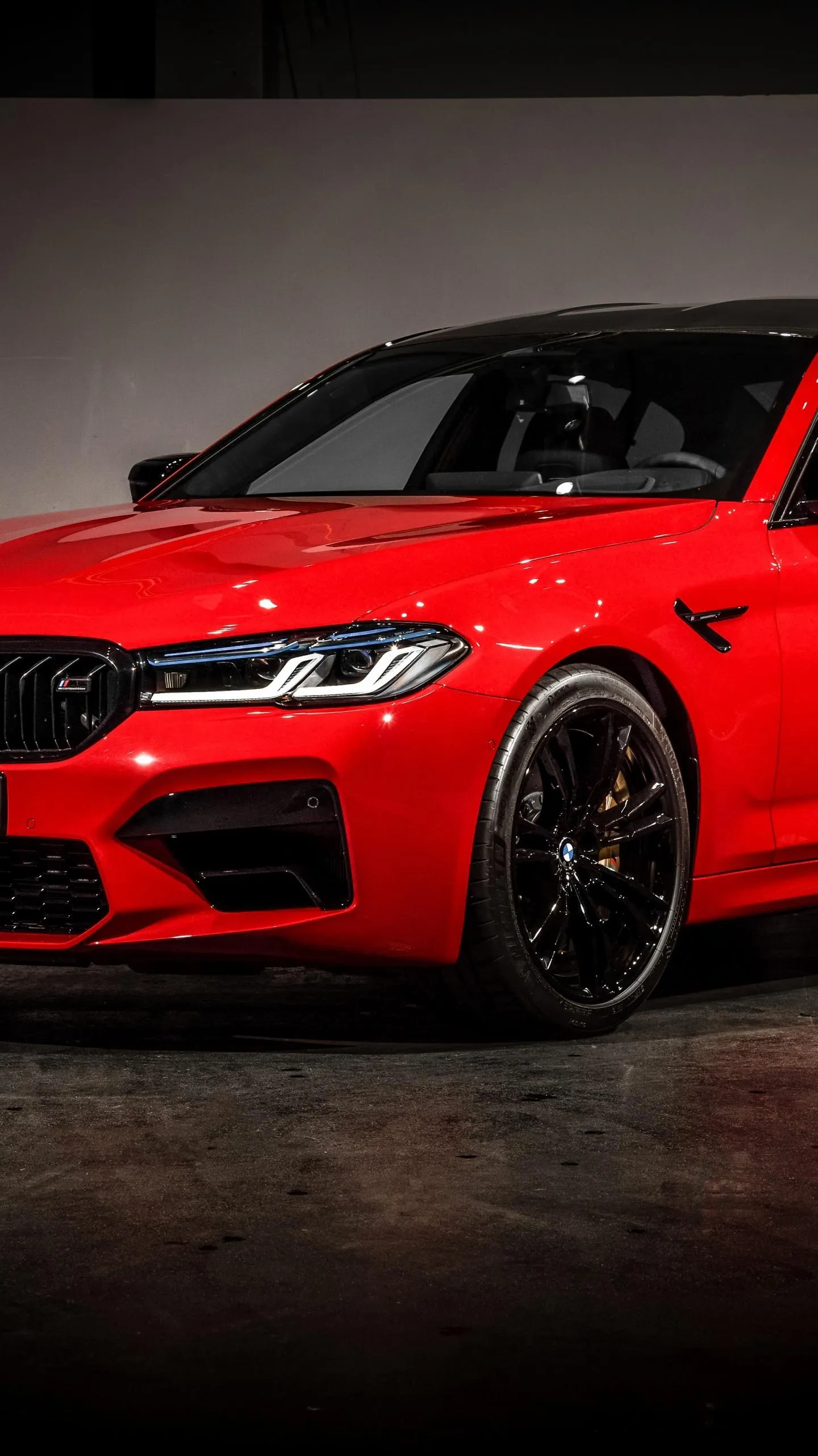 Red Bmw Sports Car Parked in Dark Indoor Setting Wallpaper