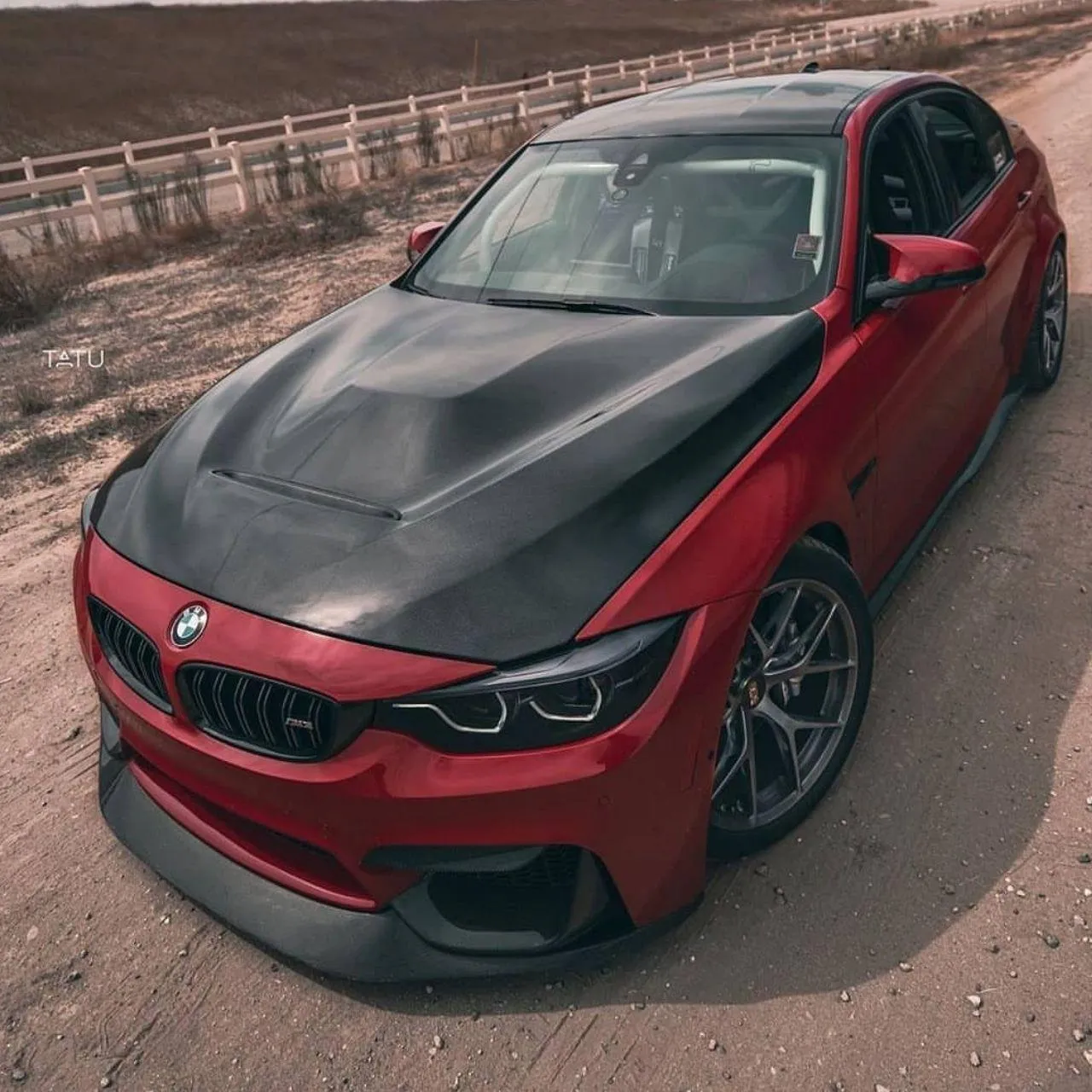Red Bmw Sports Car with Black Hood Parked on Road Image