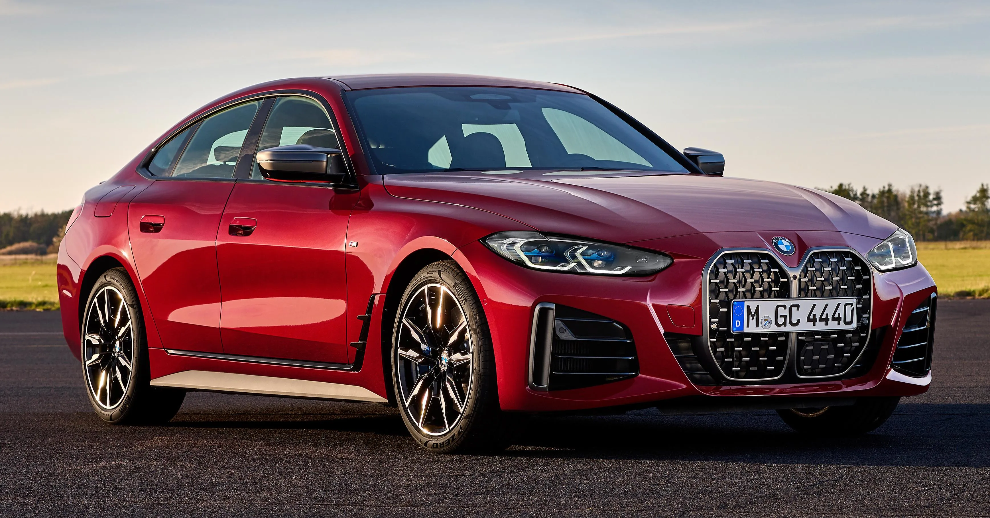Red Bmw Sports Sedan Under Sunset with Clean Background
