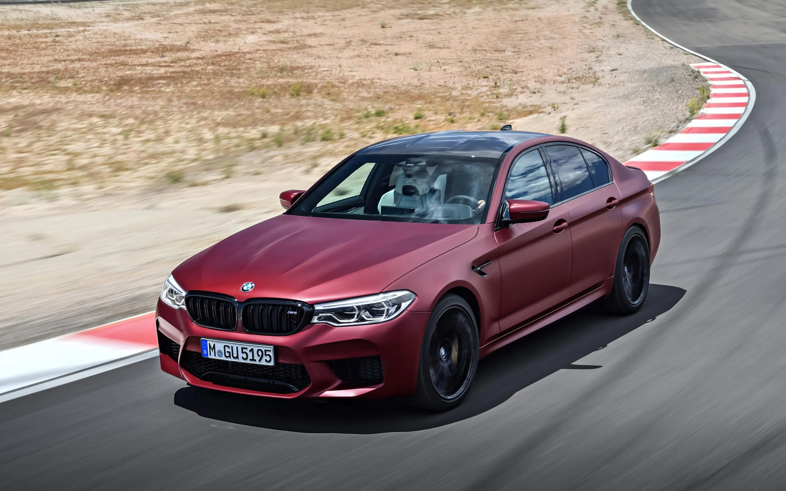 Red Bmw Sporty Coupe Driving on Race Track with Sharp Curves