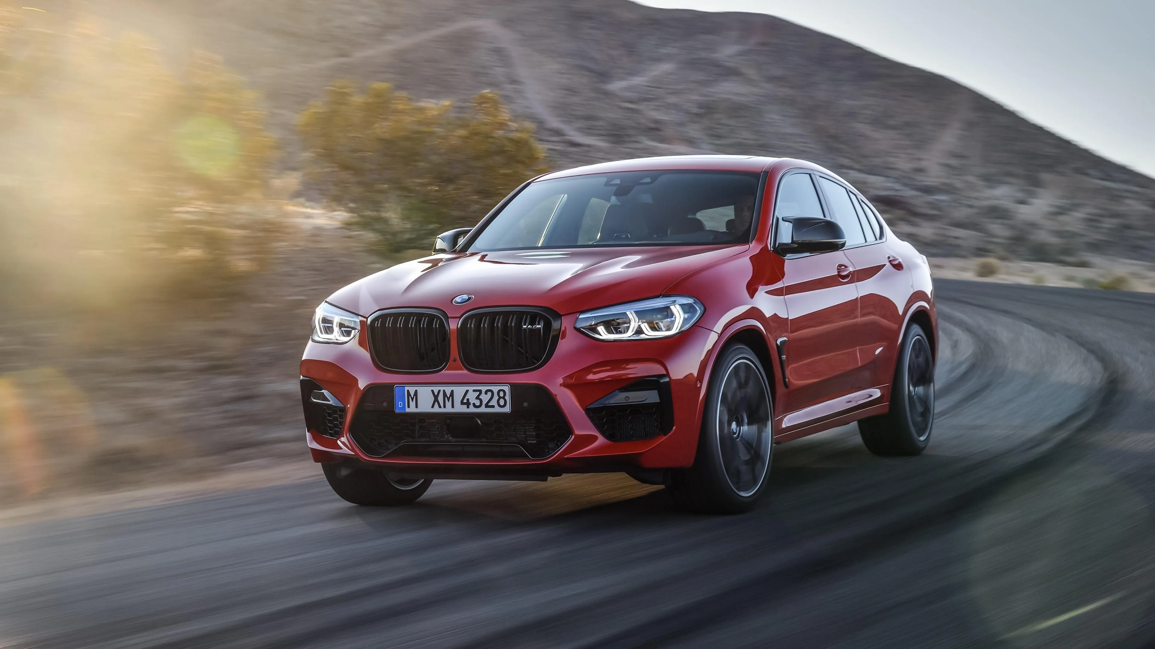 Red Bmw Suv Drifting on Mountain Curve Road with Motion Blur