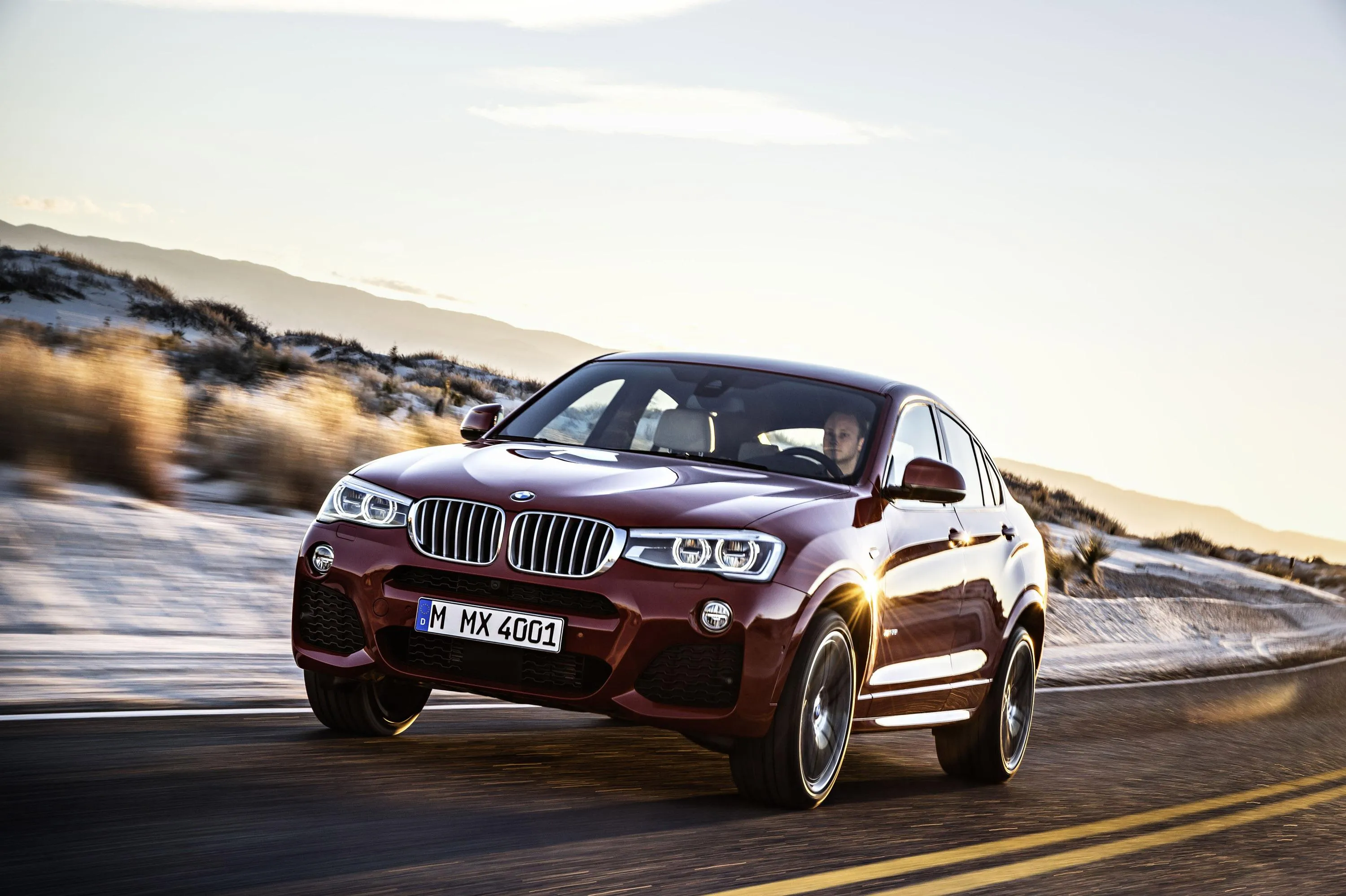 Red Bmw Suv Driving Along a Coastal Road Free Wallpaper