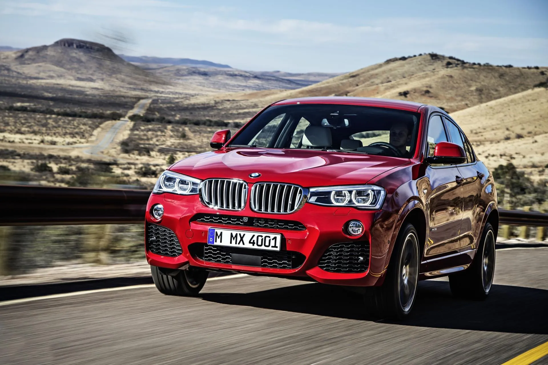 Red Bmw Suv Driving on Scenic Road in Desert Mountain Area
