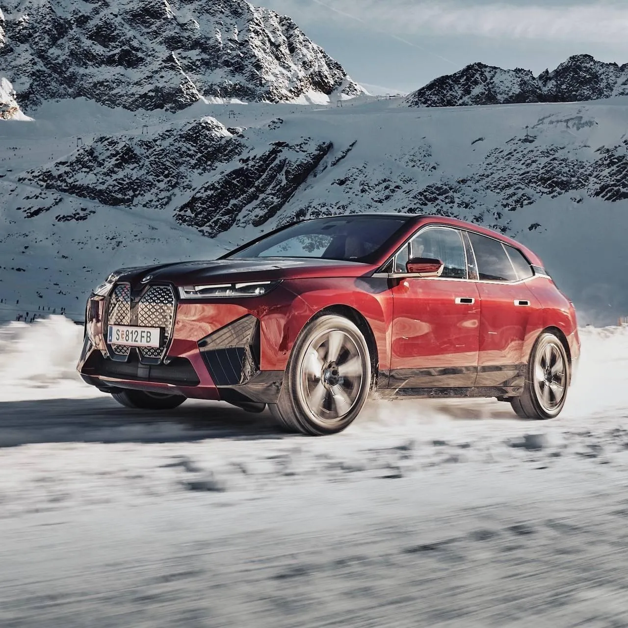 Red Bmw Suv Driving on Snowy Mountain Terrain Wallpaper