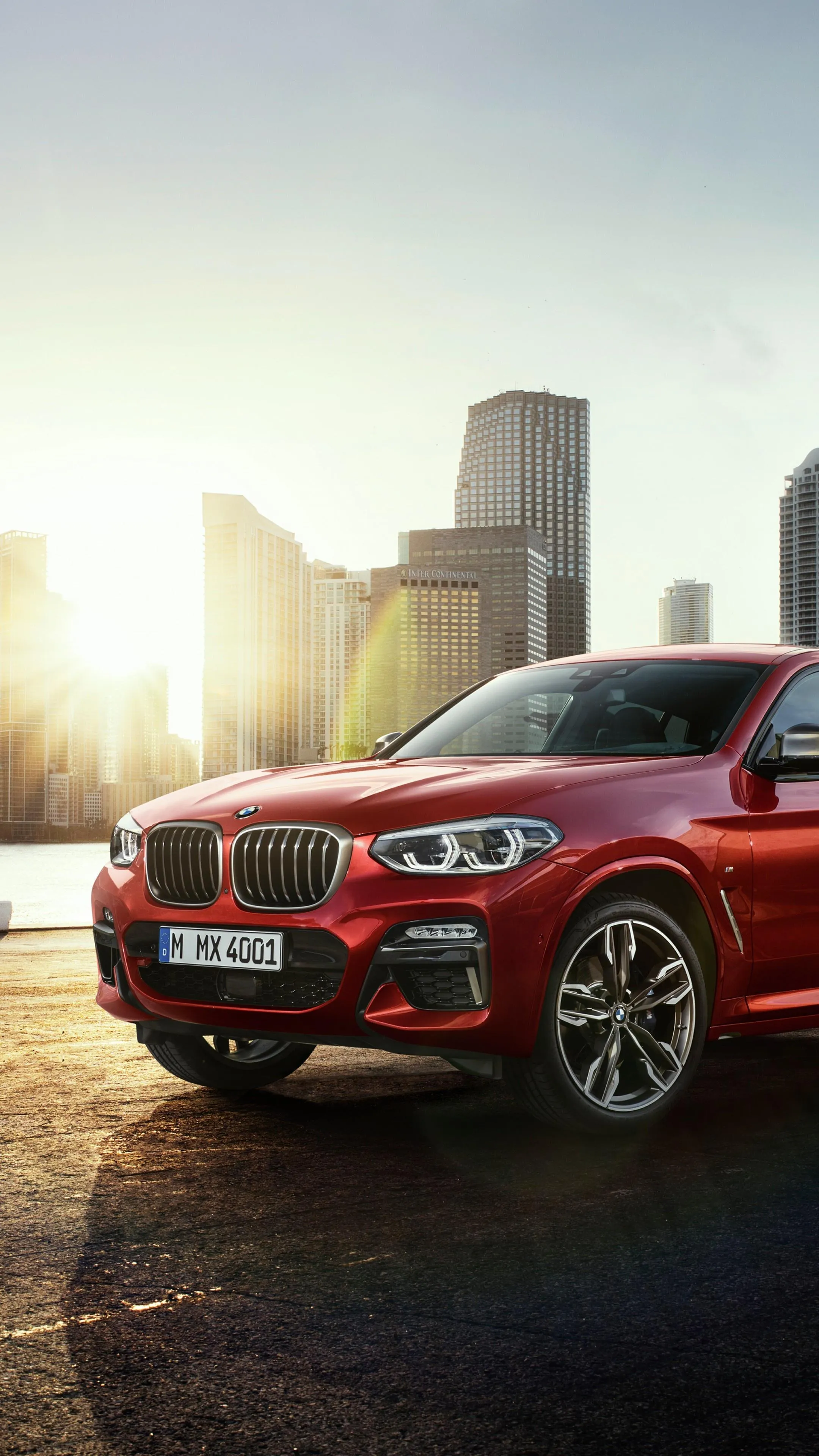 Red Bmw Suv Parked in the City During Sunset Wallpaper