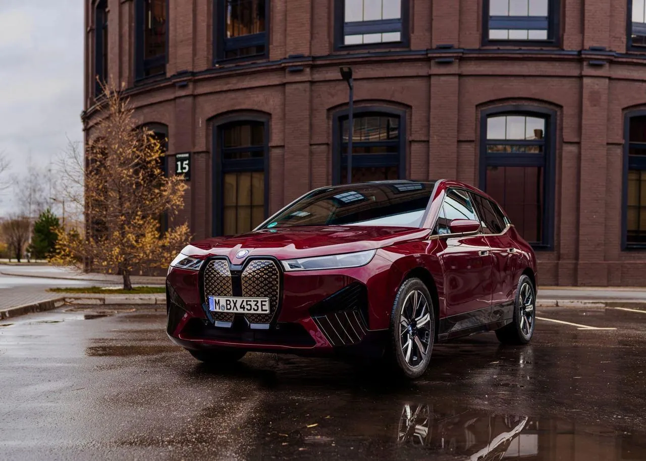 Red Bmw Suv Parked Outside a Brick Industrial Style Building