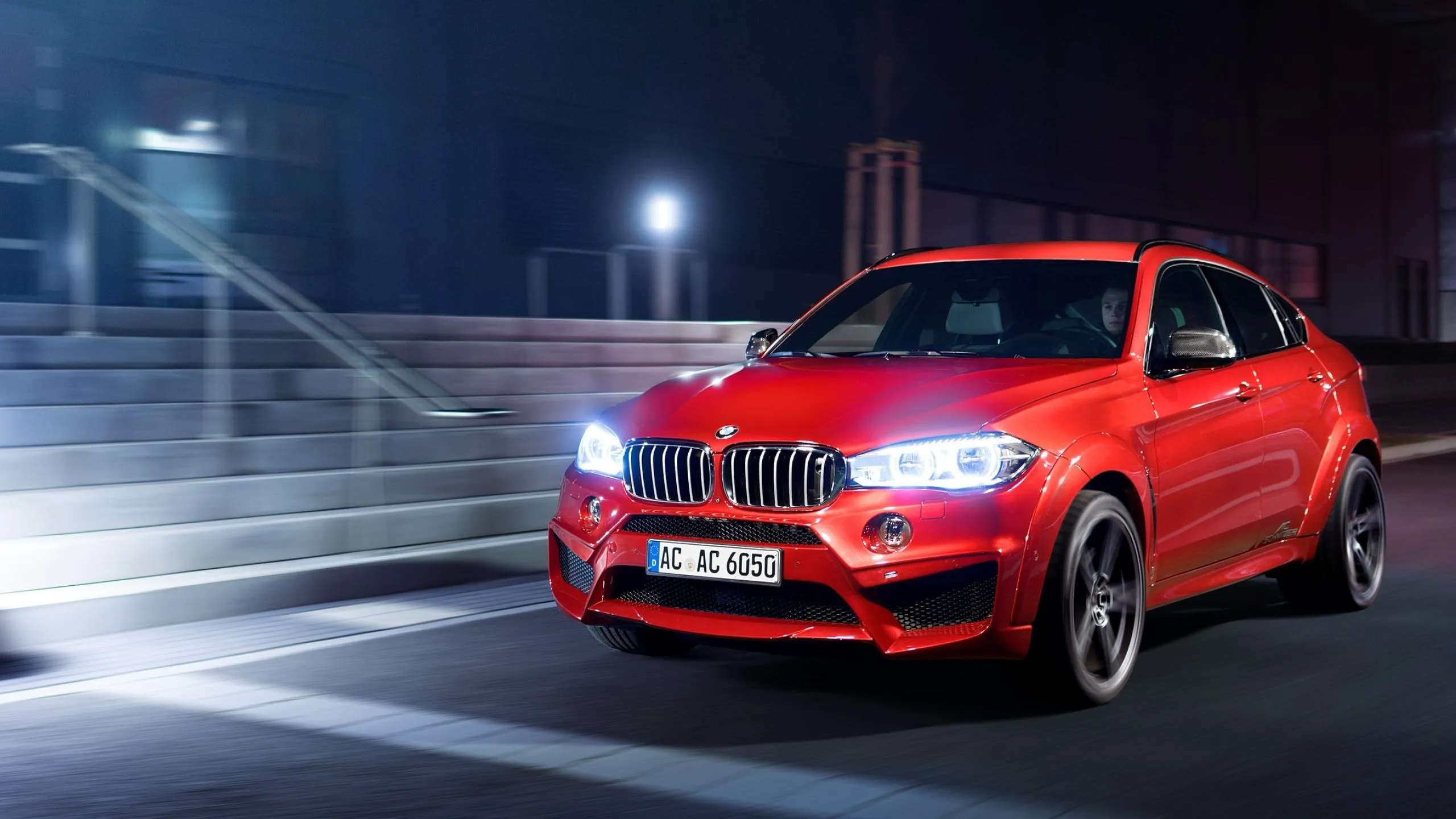Red Bmw Suv with Bright Headlights on Dark Road Night