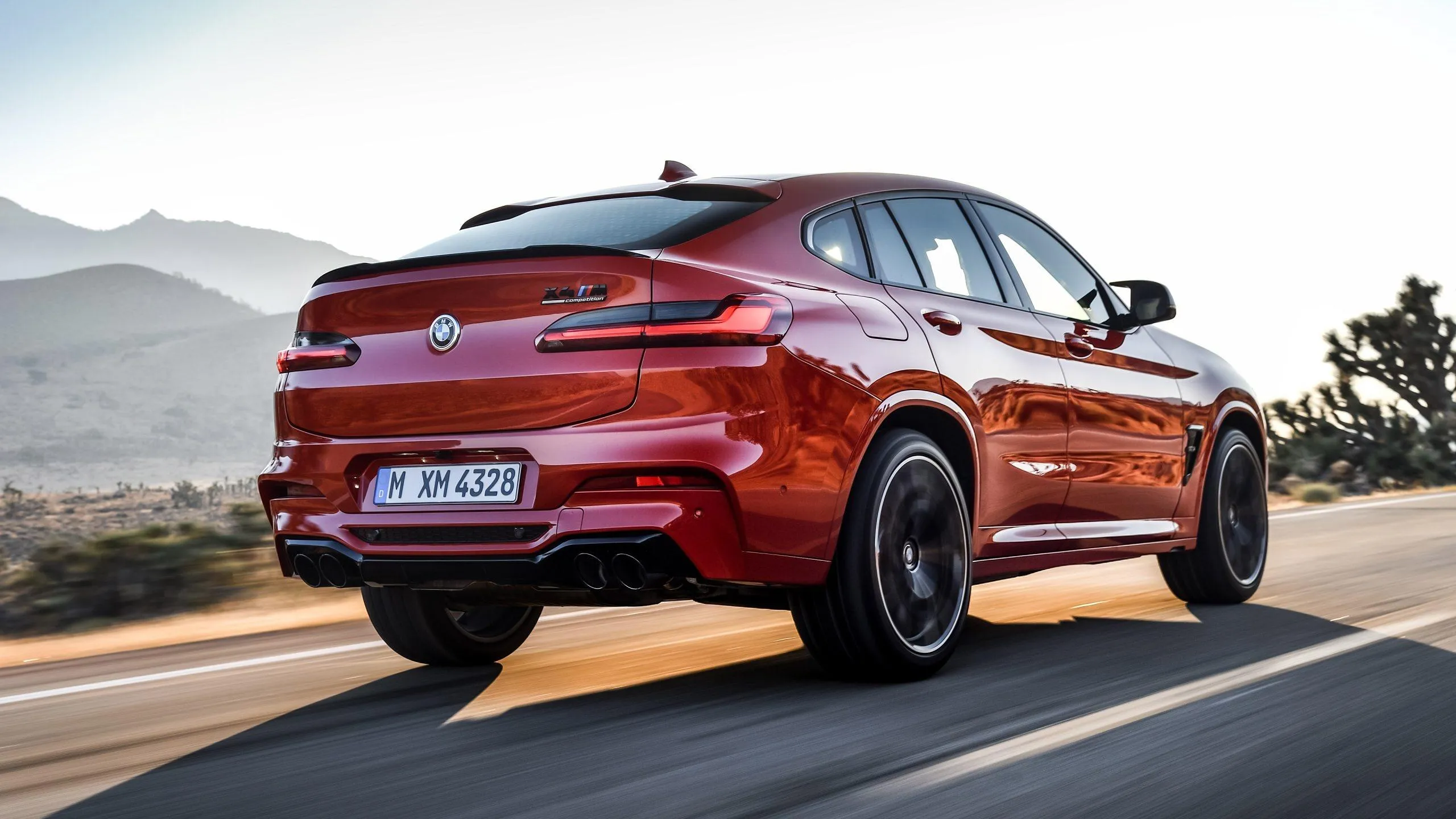 Red Bmw X6 Speeding on Road with Mountain Backdrop