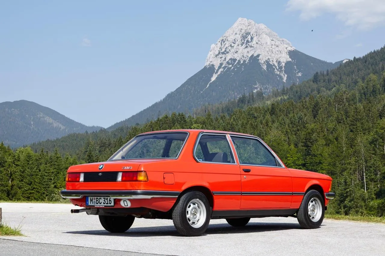 Red Classic Bmw Car Parked with Mountain Background