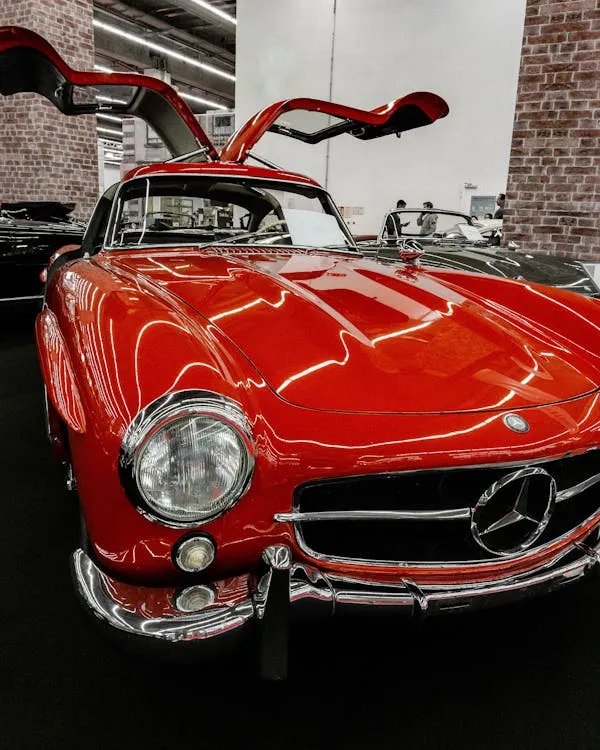 Red classic Mercedes with gullwing doors fully opened