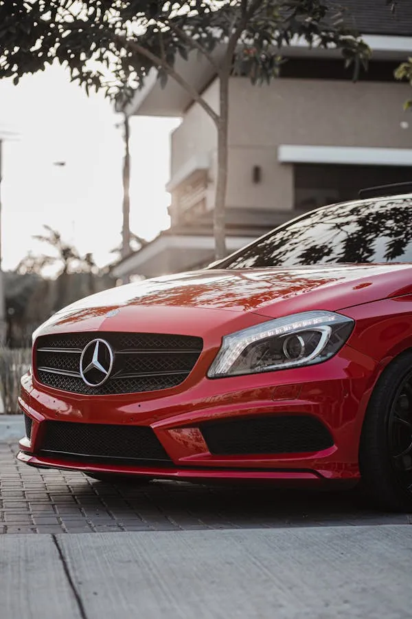 Red Mercedes Benz Coupe Parked in Suburban Driveway image
